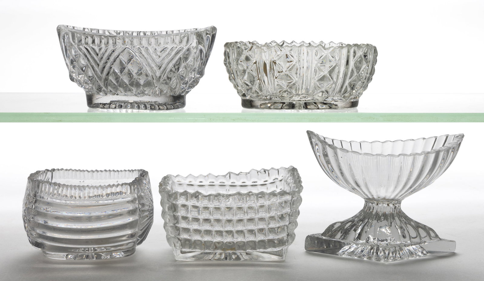 BLOW-OVER AND CRACK-OFF OPEN SALTS, LOT OF FIVE: BLOW-OVER AND CRACK-OFF OPEN SALTS, LOT OF FIVE, colorless lead and non-lead glass, comprising two rectangular/oblong examples, one with sunburst ends and ribbed sides, the other with an all-over waff