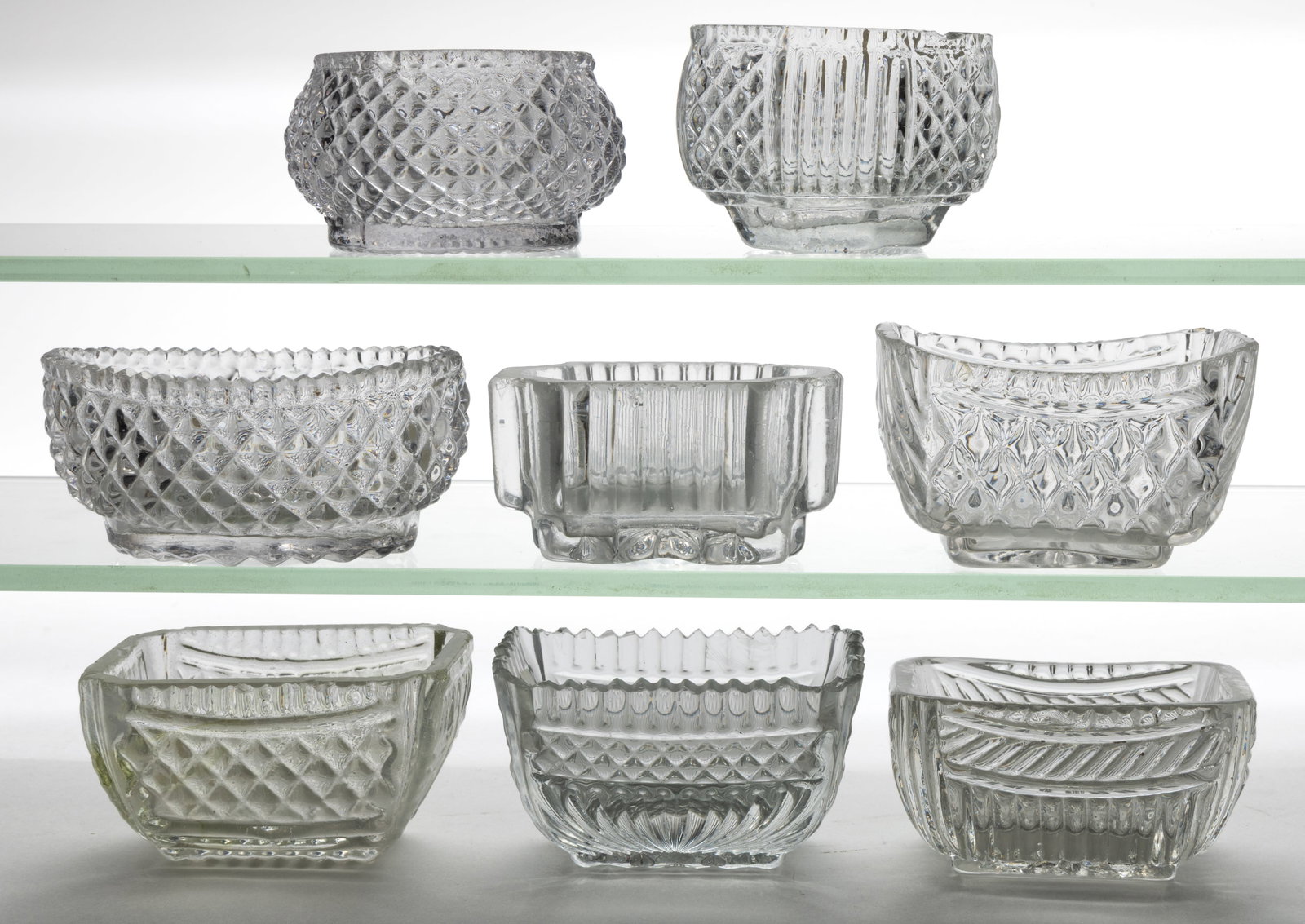 BLOW-OVER AND CRACK-OFF OPEN SALTS, LOT OF EIGHT: BLOW-OVER AND CRACK-OFF OPEN SALTS, LOT OF EIGHT, colorless lead and non-lead glass, various forms and patterns including diamond and ribs. Each rim is factory-ground and polished smooth or serra