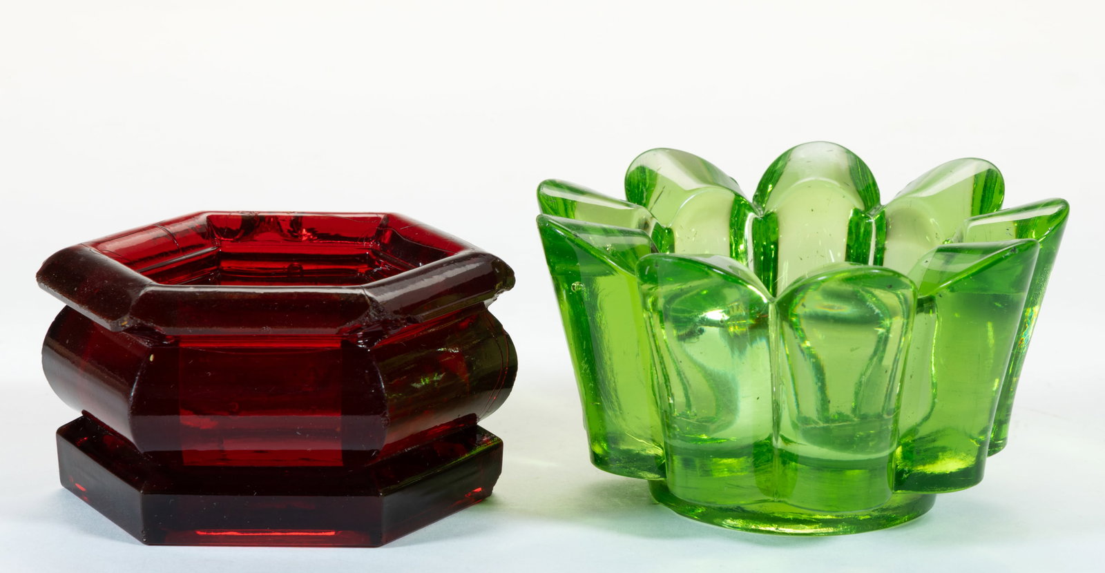 ASSORTED HEAVY PRESSED SALTS, LOT OF TWO: ASSORTED HEAVY PRESSED SALTS, LOT OF TWO, rare ruby red and apple green (reacts under blacklight), comprising a low hexagonal example with a polished pontil mark in a rare ruby red coloration; and a