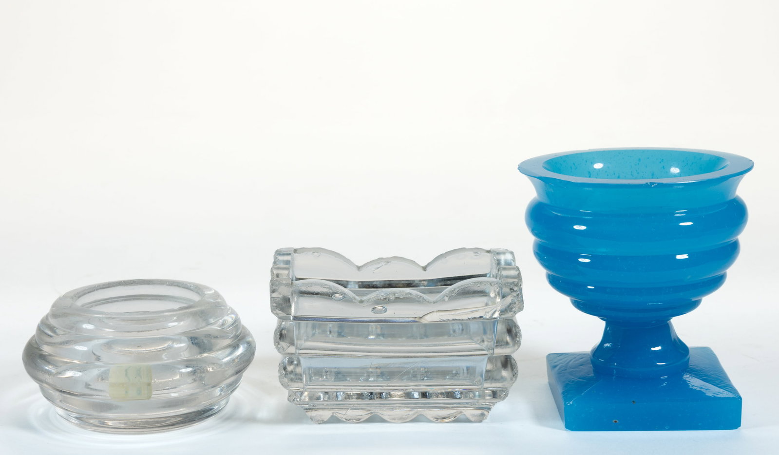 HEAVY BEEHIVE PRESSED OPEN SALTS, LOT OF THREE: HEAVY BEEHIVE PRESSED OPEN SALTS, LOT OF THREE, colorless and starch blue, comprising a footed example, rectangular form with curved, even-scallop rim above two conforming ribs, base with three