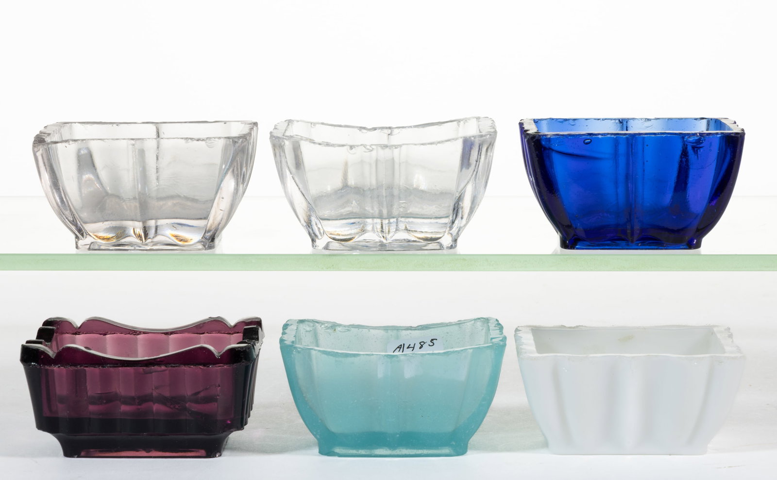EARLY PRESSED GLASS OPEN SALTS, LOT OF SIX: EARLY PRESSED GLASS OPEN SALTS, LOT OF SIX, colorless, amethyst, cobalt blue, opaque white/milk glass, and starch blue, each rectangular form. Various makers. 1840-1860. 1 3/8" to 1 1/2
