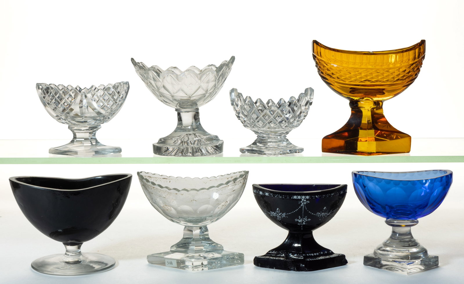 ASSORTED ANGLO-IRISH CUT AND OTHER PEDESTAL OPEN SALTS, LOT OF EIGHT: ASSORTED ANGLO-IRISH CUT AND OTHER PEDESTAL OPEN SALTS, LOT OF EIGHT, including colorless, medium blue, amethyst, and amber, each of a similar form with a boat-form bowl on a pedestal, one example dec