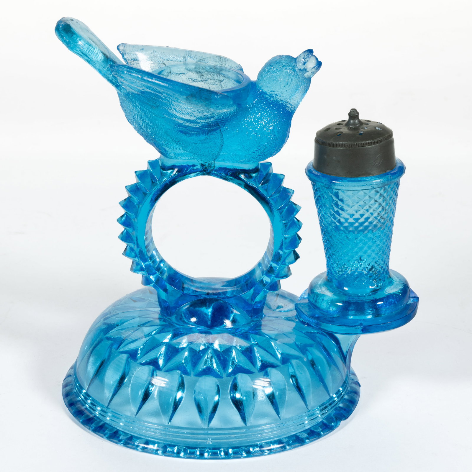 BIRD AND BERRY COMBINATION NAPKIN RING AND SALT CELLAR: BIRD AND BERRY COMBINATION NAPKIN RING AND SALT CELLAR, blue. Circa 1875. Stand: 5" H; Shaker: 2 3/4" H. Literature: Parallels the Sanfords - Victorian Glass Novelties, p. 107, top, right. P
