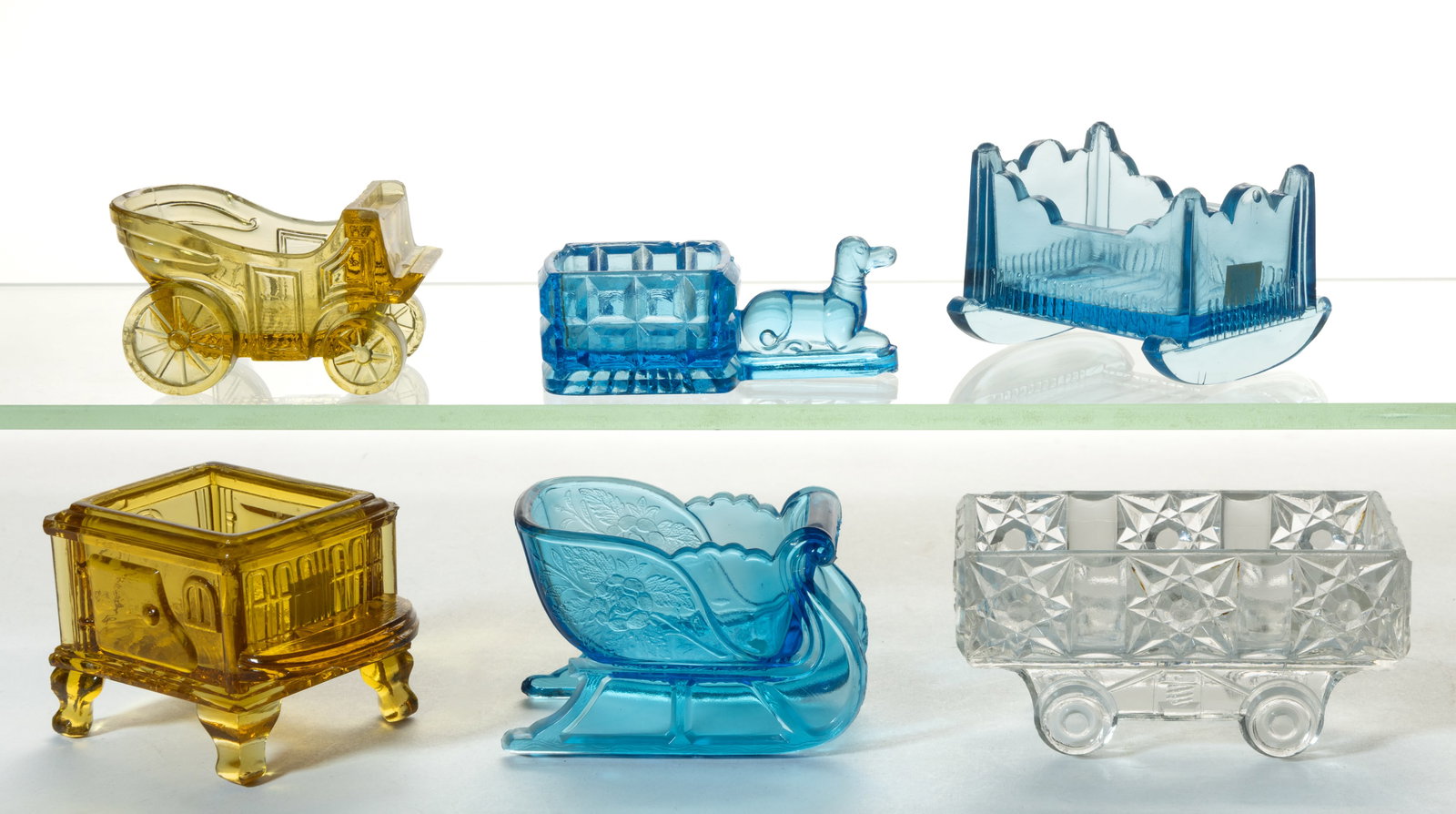 PRESSED NOVELTY GLASS OPEN SALT, LOT OF SIX: PRESSED NOVELTY GLASS OPEN SALT, LOT OF SIX, including a Dog, a Stars and Bars Wagon, a Sleigh, and a Stove. Various makers. Fourth quarter 19th/first quarter 20th century. 1 1/4" to 2 1/8&q