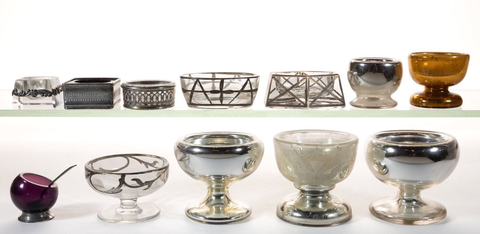 ASSORTED SILVERED / MERCURY GLASS AND SILVER-PLATED SALTS, LOT OF 12: ASSORTED SILVERED / MERCURY GLASS AND SILVER-PLATED SALTS, LOT OF 12, including four silvered mercury glass examples, one with a hand-painted enamel ship decoration, one amber example with a silvered 