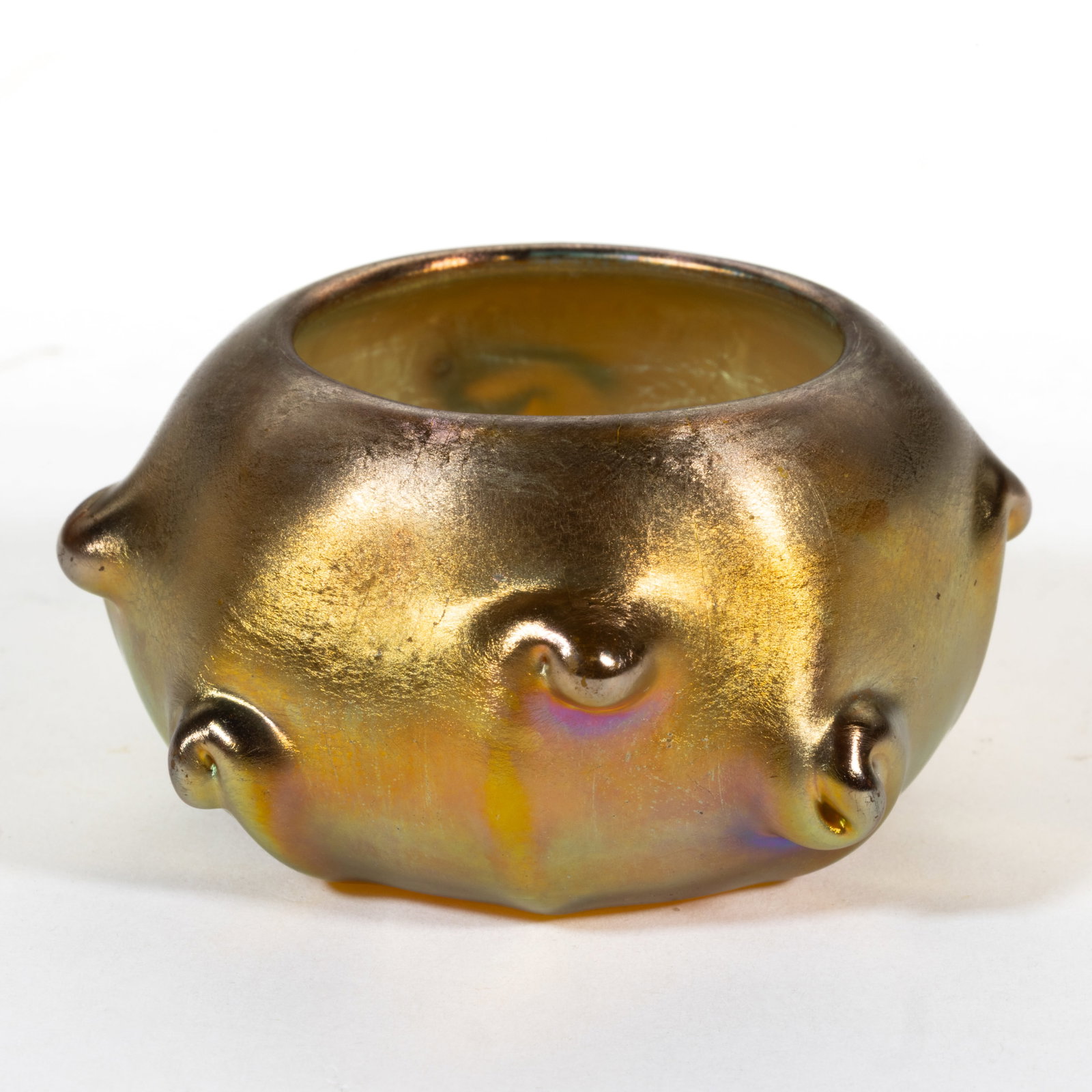 TIFFANY STUDIOS PRUNT IRIDESCENT ART GLASS OPEN SALT: TIFFANY STUDIOS PRUNT IRIDESCENT ART GLASS OPEN SALT, gold iridescent, having eight prunts, signed to the underside "L.C.T.", factory-polished base and polished pontil mark. Tiffany Studios.