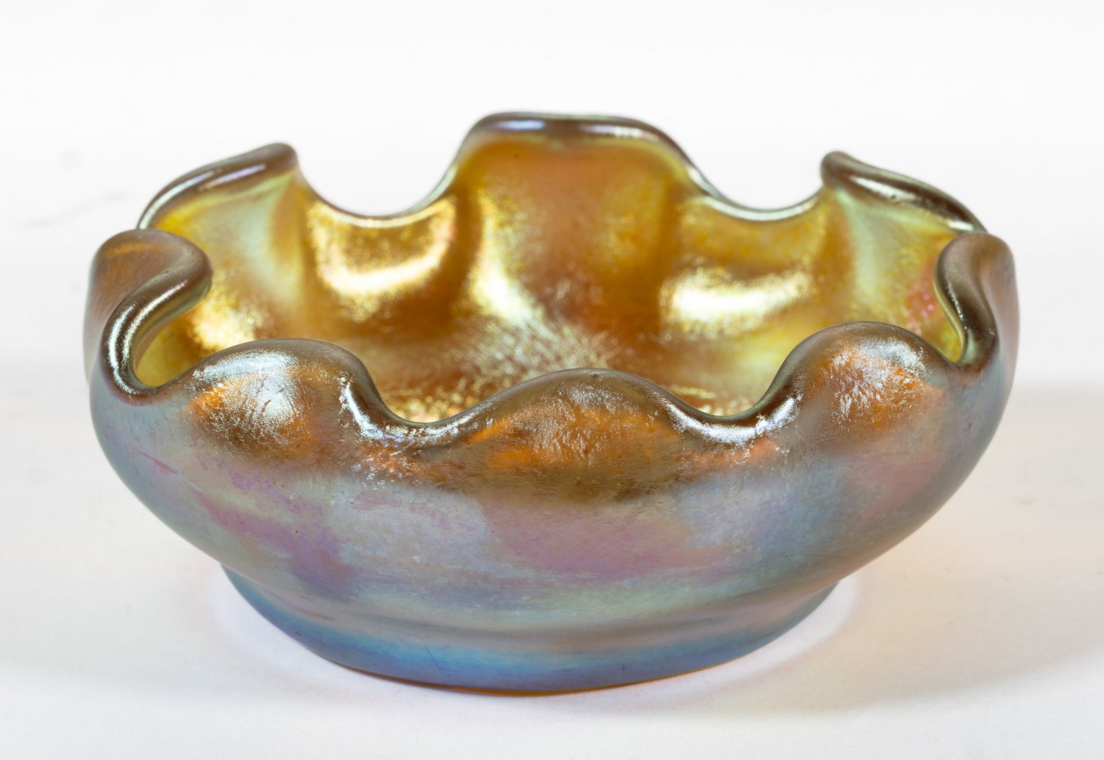 TIFFANY STUDIOS IRIDESCENT ART GLASS OPEN SALT: TIFFANY STUDIOS IRIDESCENT ART GLASS OPEN SALT, golden iridescent, dish form with tooled rim, factory polished-base and polished pontil mark. Tiffany Studios. First quarter 20th century. 1" 