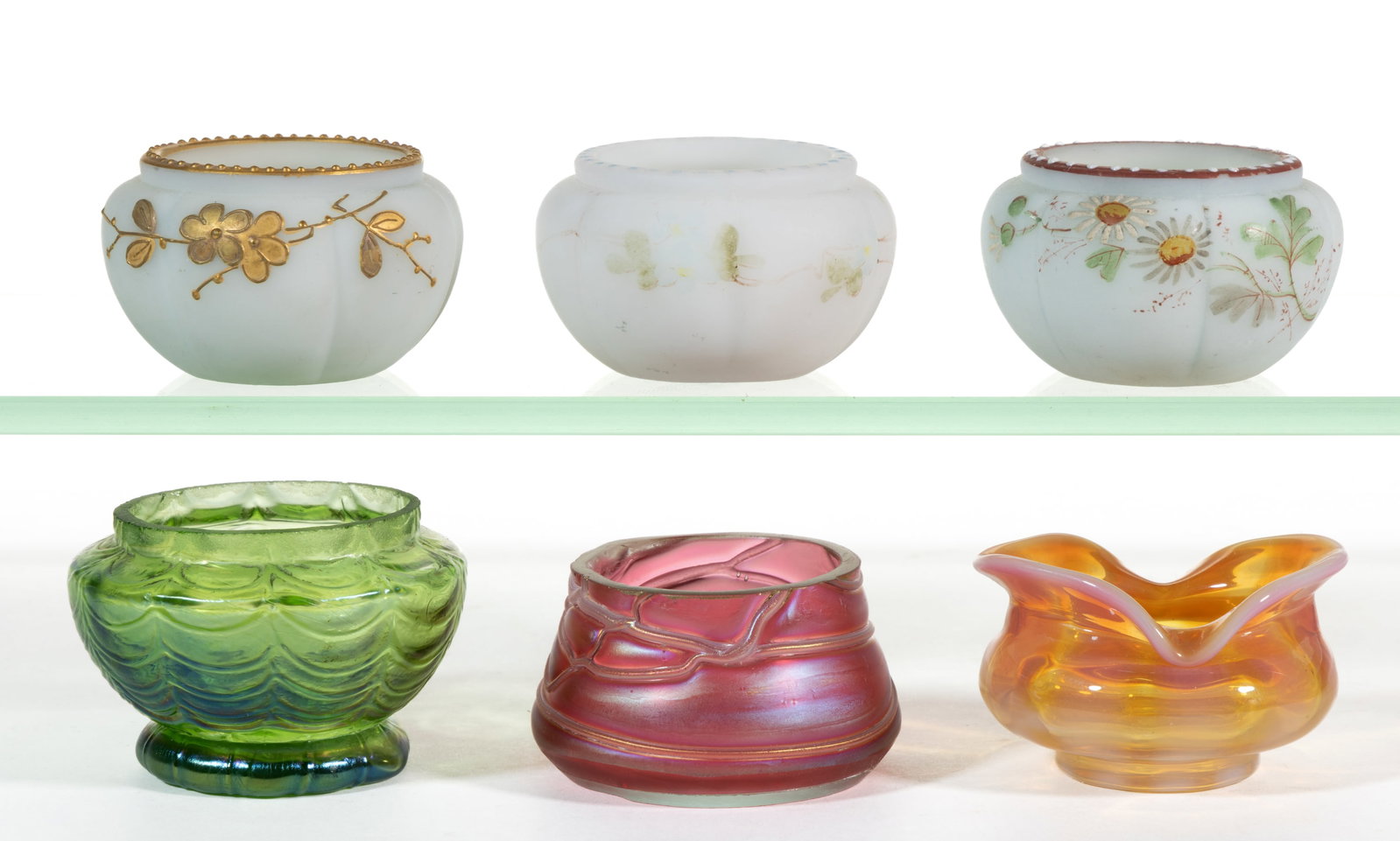 ASSORTED ART GLASS OPEN SALTS, LOT OF SIX: ASSORTED ART GLASS OPEN SALTS, LOT OF SIX, comprising an apricot opalescent Monot Stumpf, a green iridescent Loetz squat urn form with Drape pattern, a pink iridescent veined Pallm
