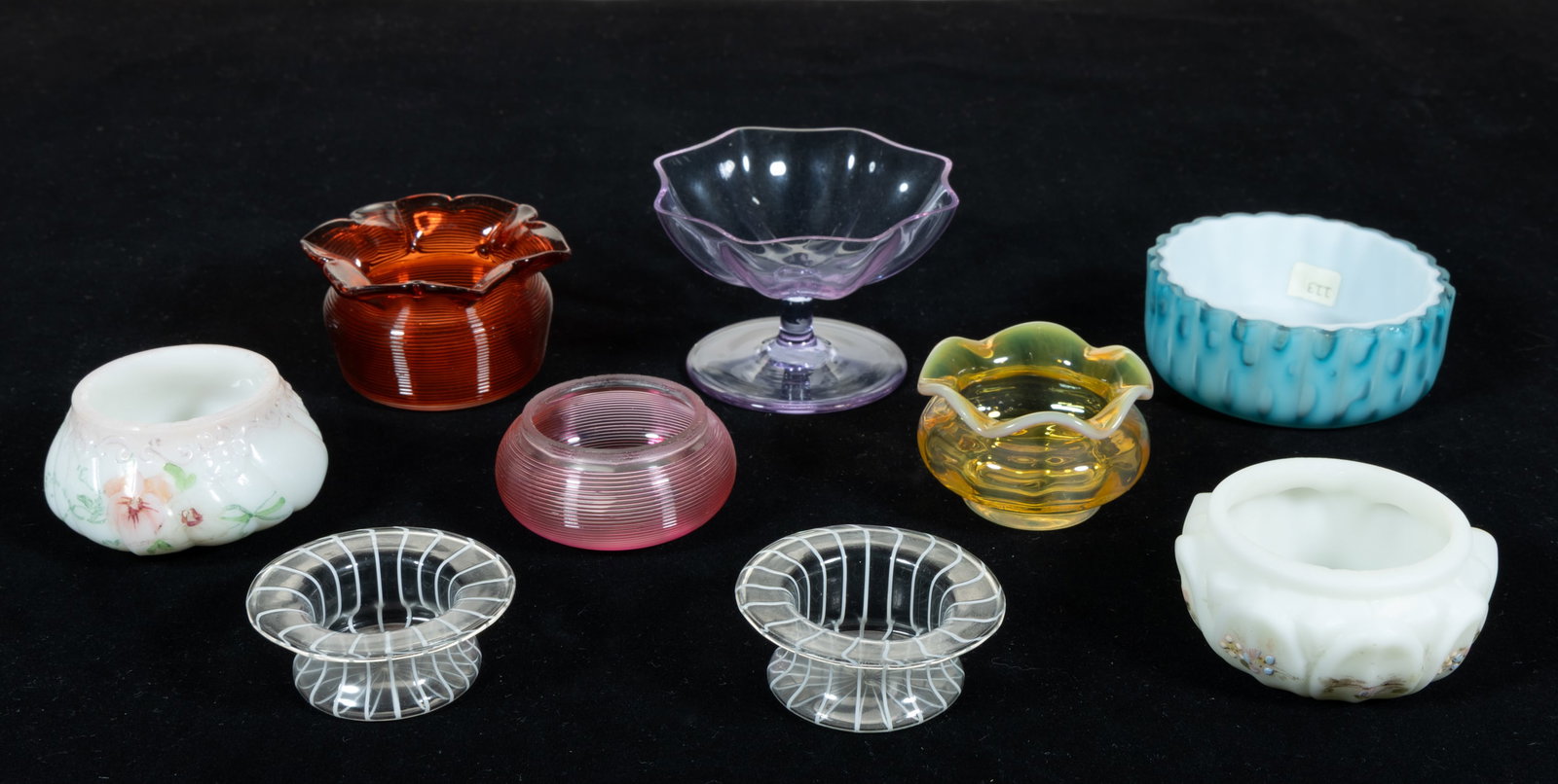 ASSORTED ART GLASS OPEN SALTS, LOT OF NINE: ASSORTED ART GLASS OPEN SALTS, LOT OF NINE, including a light apricot Monot-Stumpf with ruffled rim, a blue Raindrop Air-Trap Mother-of-Pearl, two colorless with opal stripe Murano examples, two 