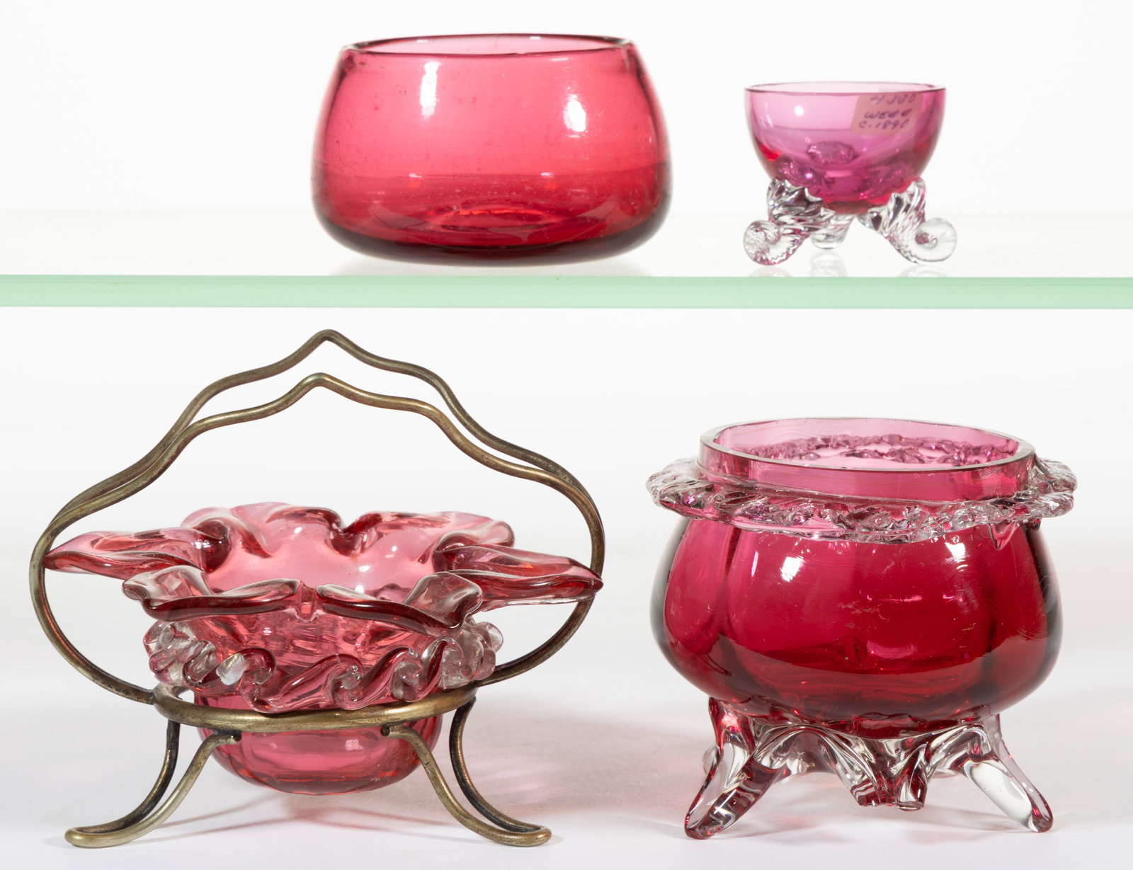 ASSORTED VICTORIAN GLASS OPEN SALTS, LOT OF FOUR: ASSORTED VICTORIAN GLASS OPEN SALTS, LOT OF FOUR, cranberry, including two with applied colorless rigaree, one of which fitted into an "EPNS" stand. Various makers. Late 19th/early 20th