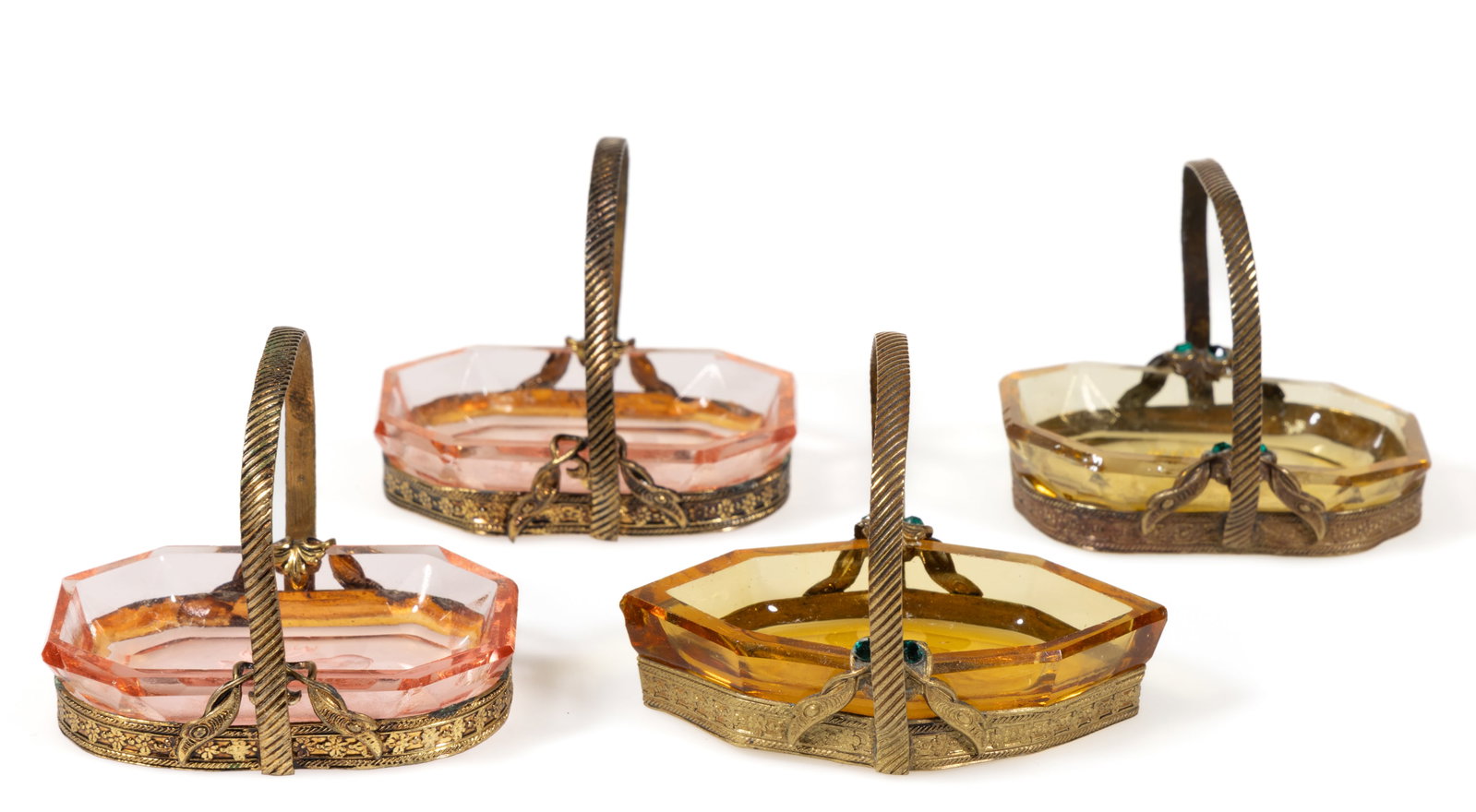 INTAGLIO GLASS OPEN SALTS IN STANDS, LOT OF FOUR: INTAGLIO GLASS OPEN SALTS IN STANDS, LOT OF FOUR, amber and pink, comprising a floral and three elk examples, each having a factory-polished rim and edge, each being fit into a gilt filigree basket wi