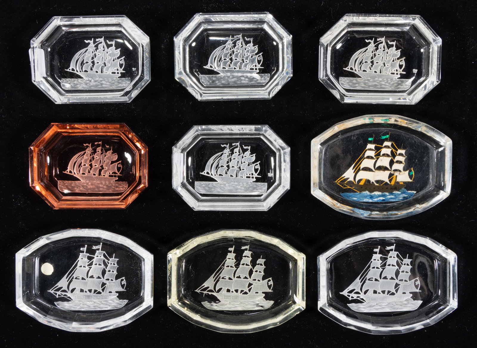 INTAGLIO GLASS OPEN SALTS, LOT OF NINE: INTAGLIO GLASS OPEN SALTS, LOT OF NINE, colorless, including one with reverse paint decoration, and one pink, each featuring a sailing/nautical scene, each having a factory-polished rim and edge. Czec