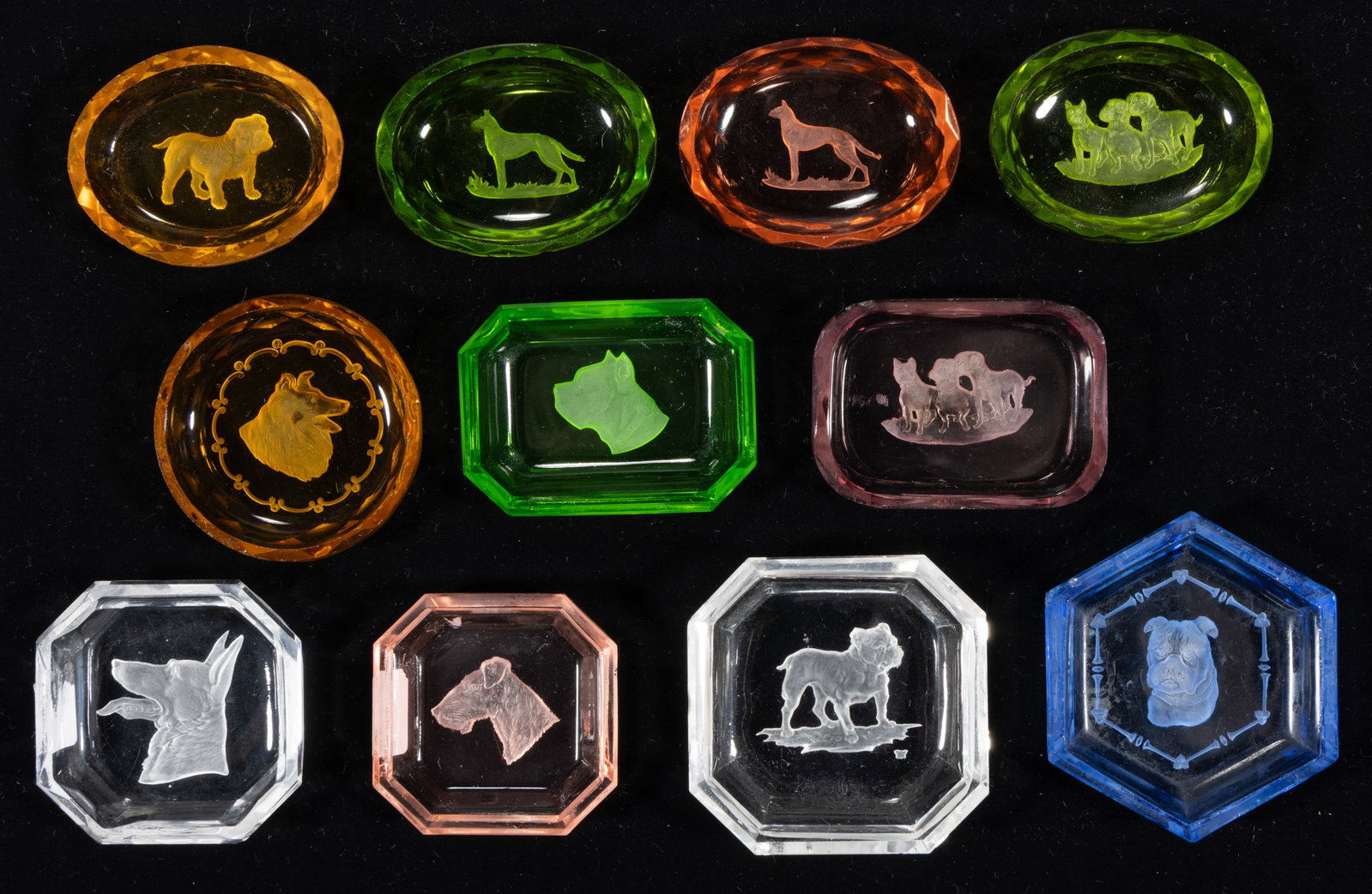 INTAGLIO GLASS OPEN SALTS, LOT OF 11: INTAGLIO GLASS OPEN SALTS, LOT OF 11, various colors including one apple green (reacts under black light), comprising various dog examples, each having a factory-polished rim and edge. Czechoslov