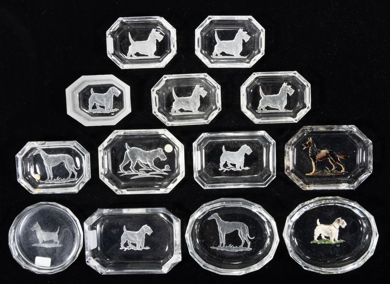 INTAGLIO GLASS OPEN SALTS, LOT OF 13: INTAGLIO GLASS OPEN SALTS, LOT OF 13, colorless including two with reverse paint decoration, featuring seven various dogs, each having a factory-polished rim and edge. Czechoslovakia, t