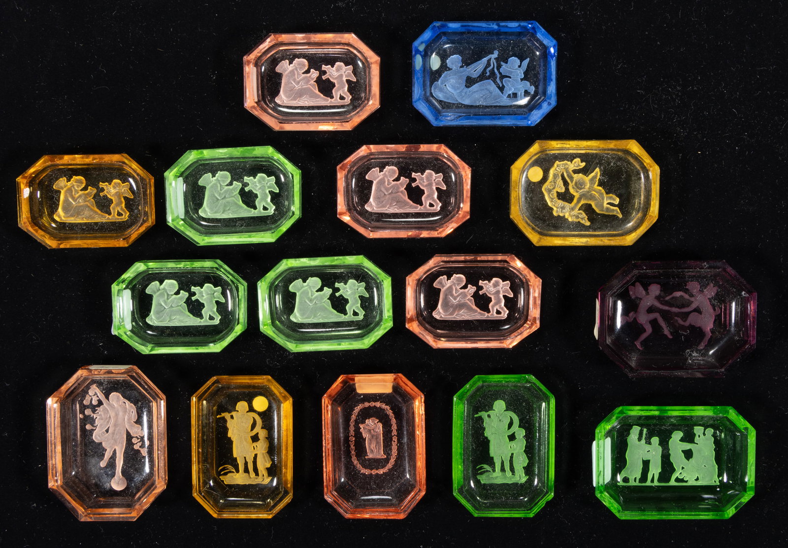 INTAGLIO GLASS OPEN SALTS, LOT OF 15: INTAGLIO GLASS OPEN SALTS, LOT OF 15, various colors including one apple green (reacts under black light), each depicting a Classical scene, one featuring two winged, dancing figures, one with a 