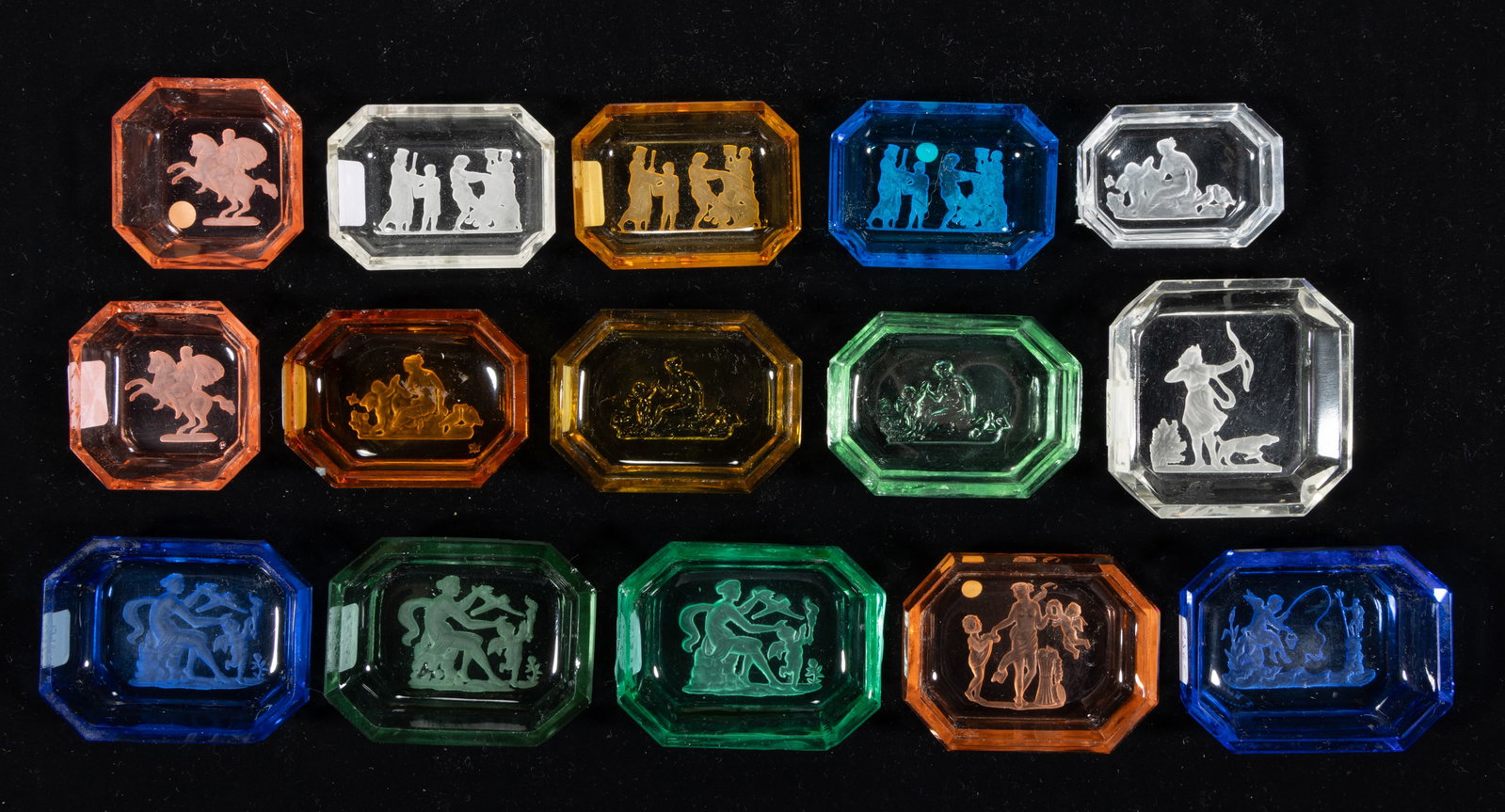 INTAGLIO GLASS OPEN SALTS, LOT OF 15: INTAGLIO GLASS OPEN SALTS, LOT OF 15, various colors, each depicting a Classical scene, each having factory-polished rim and edge. Czechoslovakia. Circa 1930. 2 1/8" to 3" DOA. Literatu