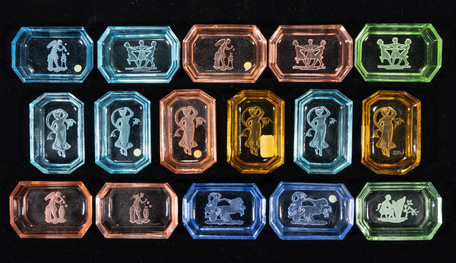 INTAGLIO GLASS OPEN SALTS, LOT OF 16: INTAGLIO GLASS OPEN SALTS, LOT OF 16, various colors, each featuring Classical figures, each having a factory-polished rim and edge. Czechoslovakia. Circa 1930. 2 5/8" DOA. Provenance: 