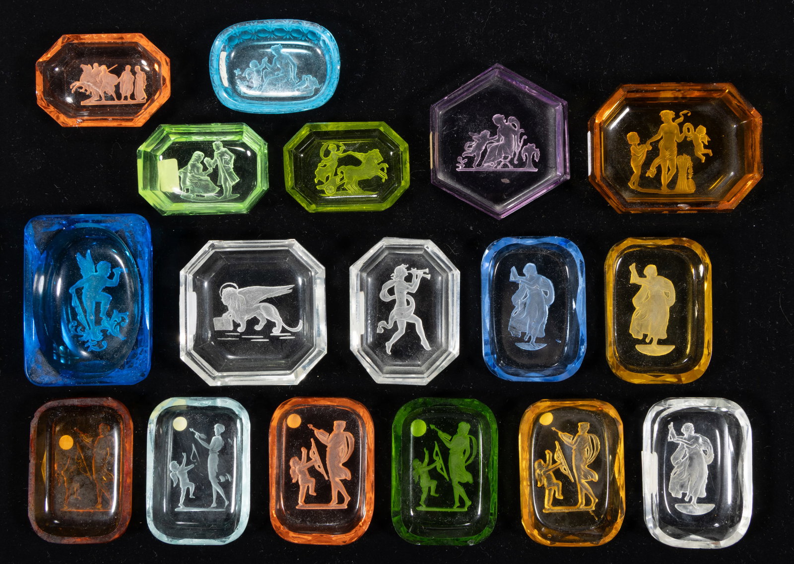 INTAGLIO GLASS OPEN SALTS, LOT OF 17: INTAGLIO GLASS OPEN SALTS, LOT OF 17, various colors, each featuring a Classical scene, each having a factory-polished rim and edge. Czechoslovakia. Circa 1930. 2 1/4" to 2 7/8" DO