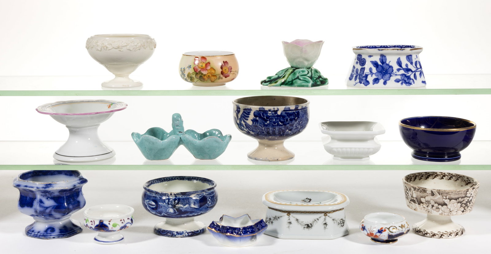 ASSORTED ENGLISH AND OTHER CERAMIC OPEN SALTS, LOT OF 16: ASSORTED ENGLISH AND OTHER CERAMIC OPEN SALTS, LOT OF 16, including one majolica floriform example, one Wedgwood cream-glazed example with applied grapevine decoration below rim, three blue 