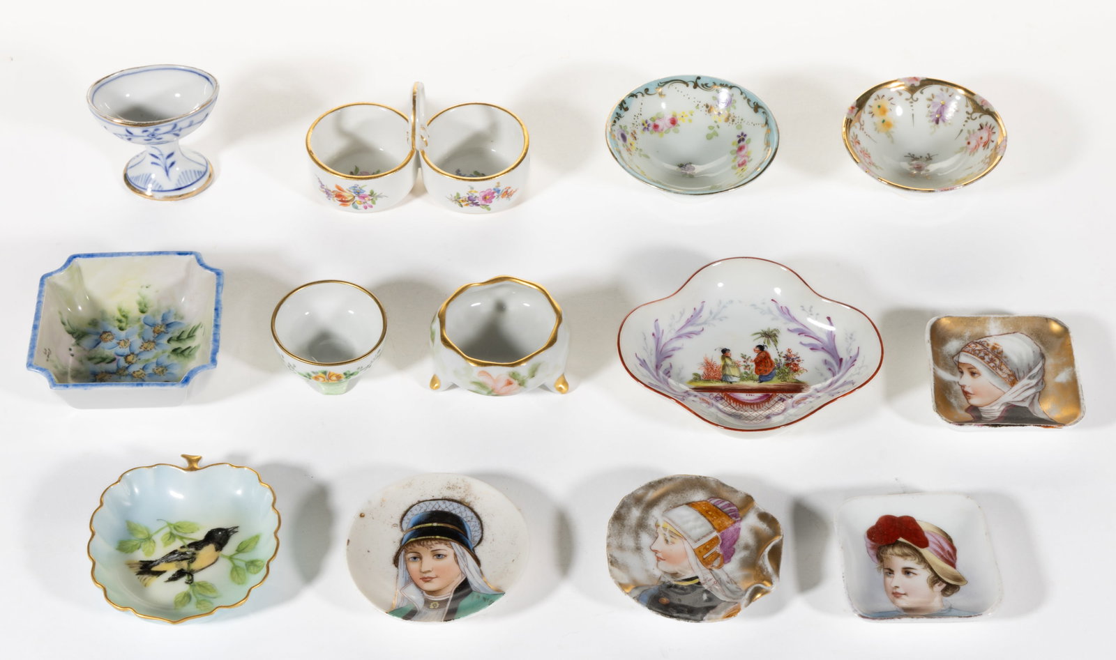 GERMAN MEISSEN PORCELAIN AND OTHER HAND-PAINTED OPEN SALTS, LOT OF 13: GERMAN MEISSEN PORCELAIN AND OTHER HAND-PAINTED OPEN SALTS, LOT OF 13, including one double Meissen example with floral motif, one Dresden quatrefoil-form example featuring two Asian figures, one R.S.