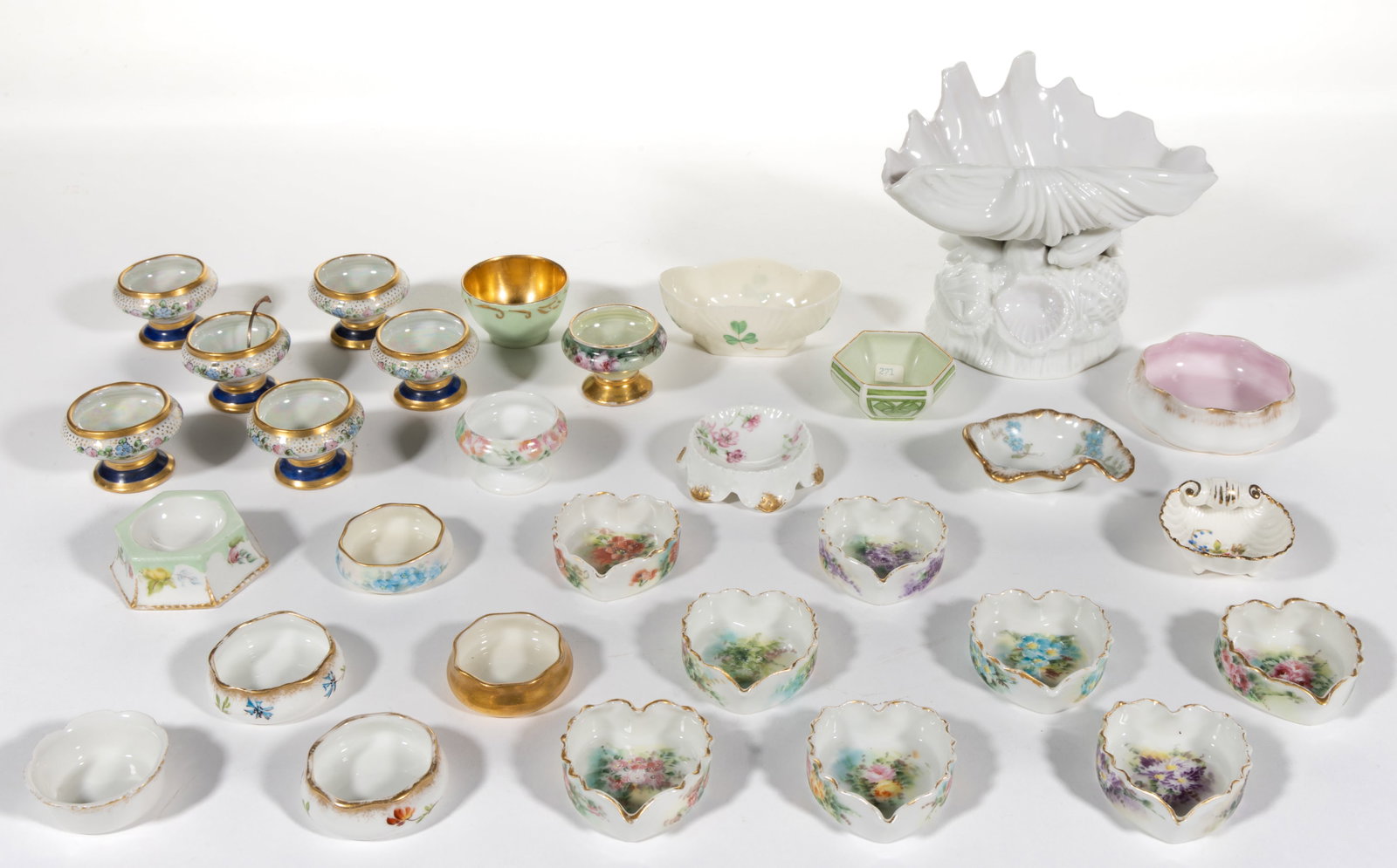 FRENCH LIMOGES AND OTHER SIMILAR PORCELAIN OPEN SALTS, LOT OF 30: FRENCH LIMOGES AND OTHER SIMILAR PORCELAIN OPEN SALTS, LOT OF 30, including eight heart-shaped examples with polychrome hand-painted floral designs, one Belleek shell and clover-decorated example