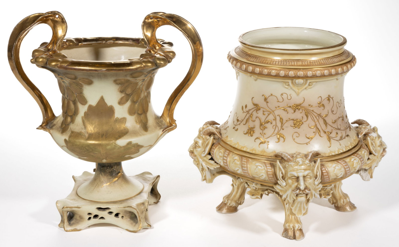 AUSTRIAN AND ENGLISH PORCELAIN IVORY VASES, LOT OF TWO: AUSTRIAN AND ENGLISH PORCELAIN IVORY VASES, LOT OF TWO, comprising a Royal Worcester example with four horned green man masks above three cloven-hoofed feet and raised gilt floral designs and an urn-f