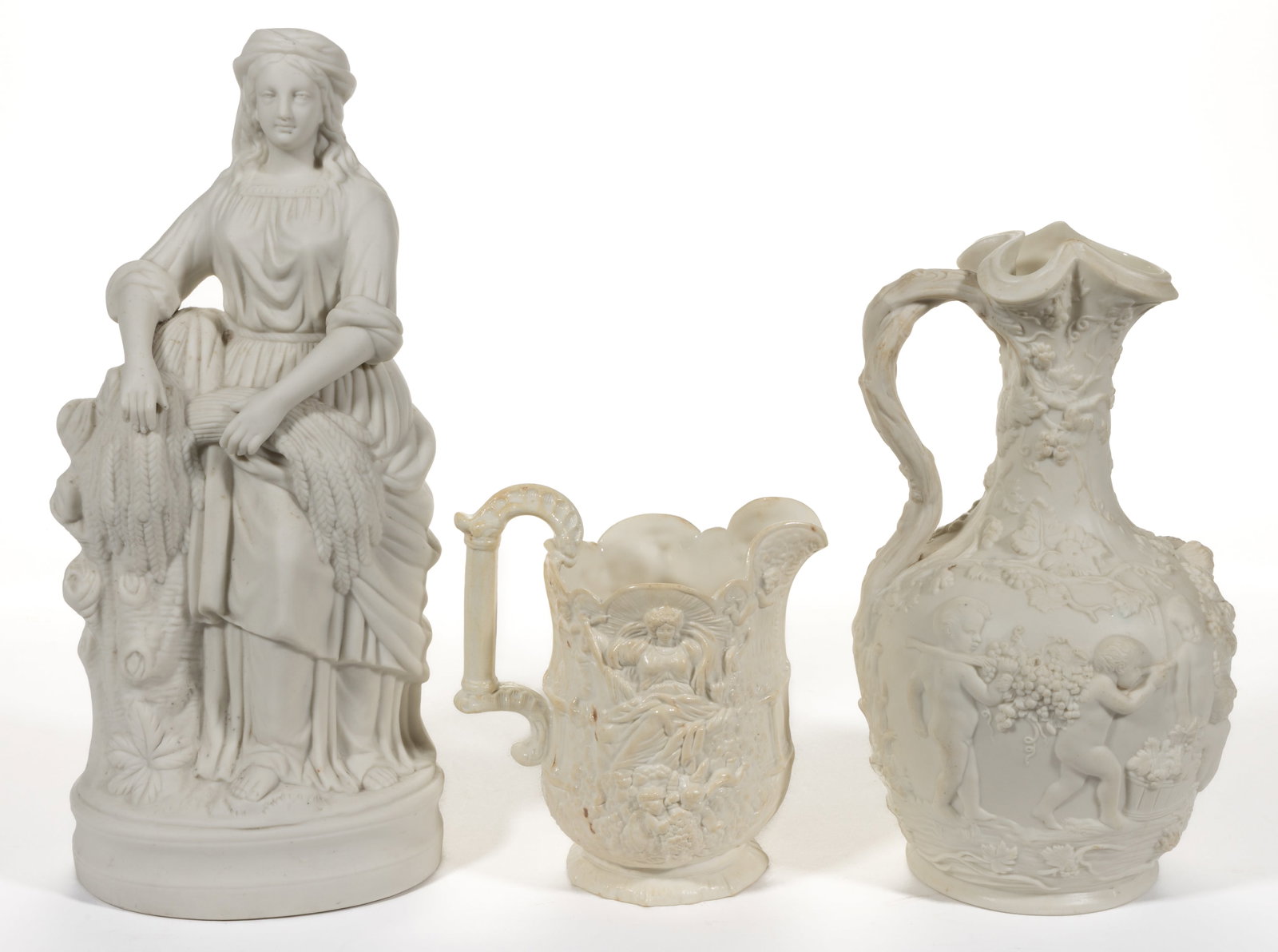 ENGLISH PARIAN PORCELAIN ARTICLES, LOT OF THREE: ENGLISH PARIAN PORCELAIN ARTICLES, LOT OF THREE, comprising a bisque figure of a woman standing on an ovoid base with sheaves of wheat resting on a tree stump beside her and two relief-molded pitchers
