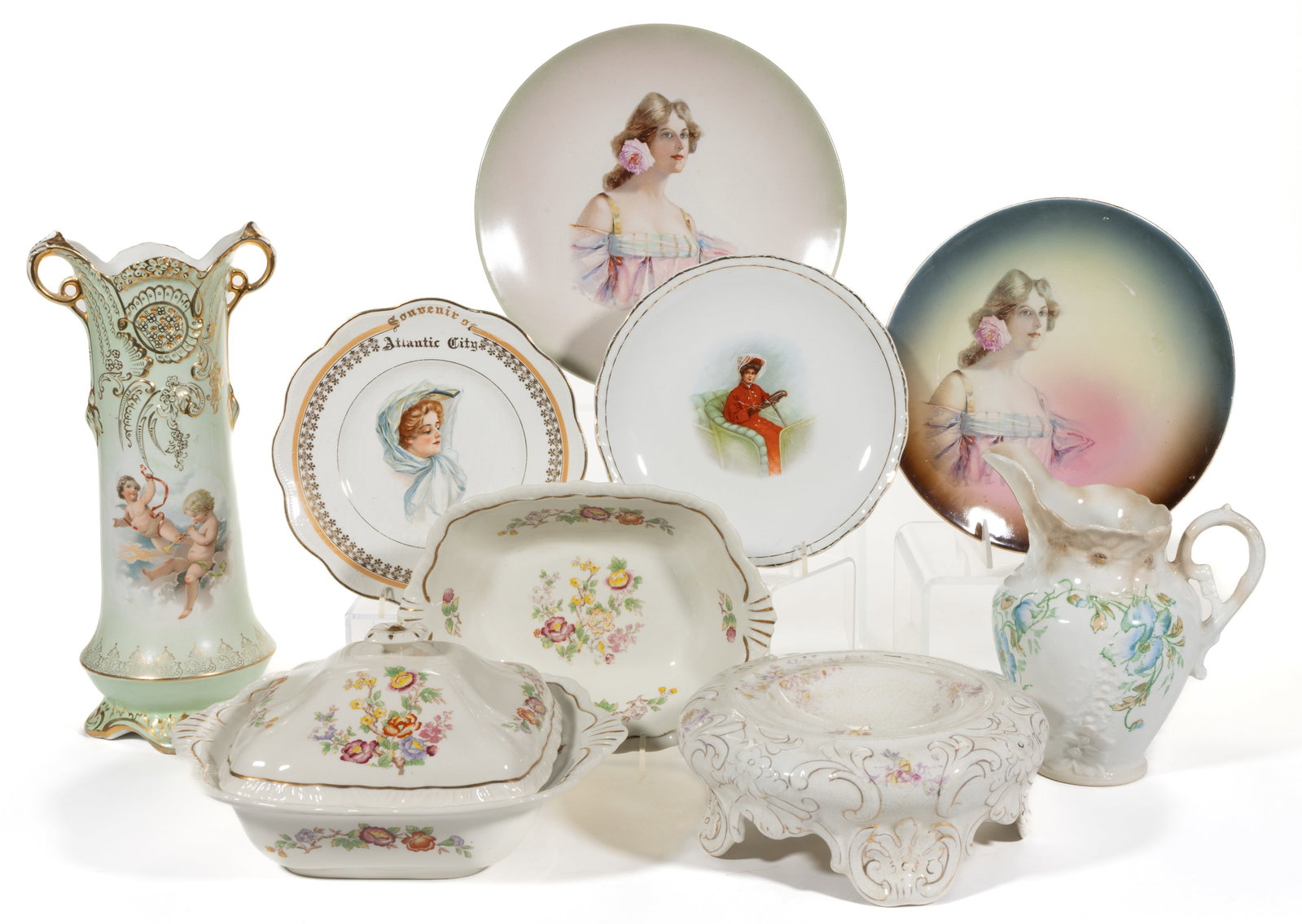 OHIO AND WEST VIRGINIA CERAMIC ARTICLES, LOT OF NINE: OHIO AND WEST VIRGINIA CERAMIC ARTICLES, LOT OF NINE, including a vase featuring two cheerful winged cherubs to each side on seafoam green ground, two examples with matching floral motif consisting of