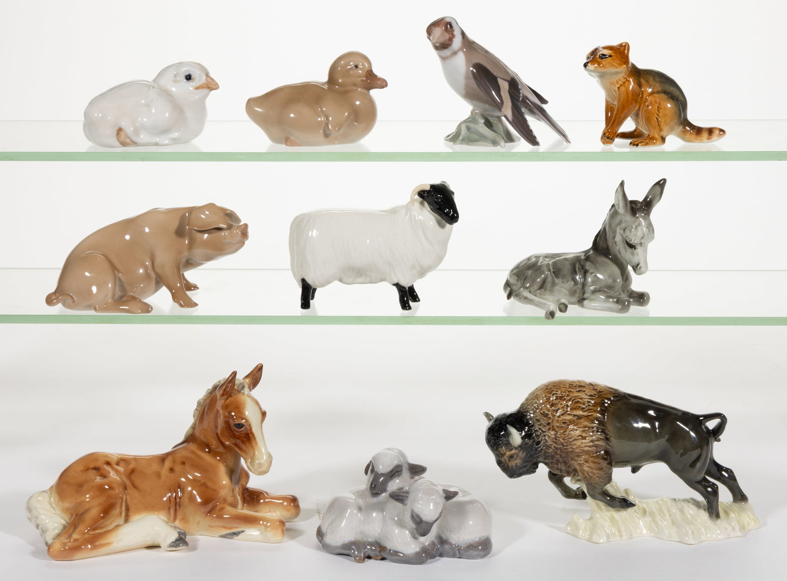ASSORTED HAND-PAINTED PORCELAIN ANIMAL FIGURES, LOT OF TEN: ASSORTED HAND-PAINTED PORCELAIN ANIMAL FIGURES, LOT OF TEN, comprising a Gort recumbent colt, a Lorenz Hutschenreuther recumbent donkey foal, a Beswick black-faced sheep with horns, two Goebel ex
