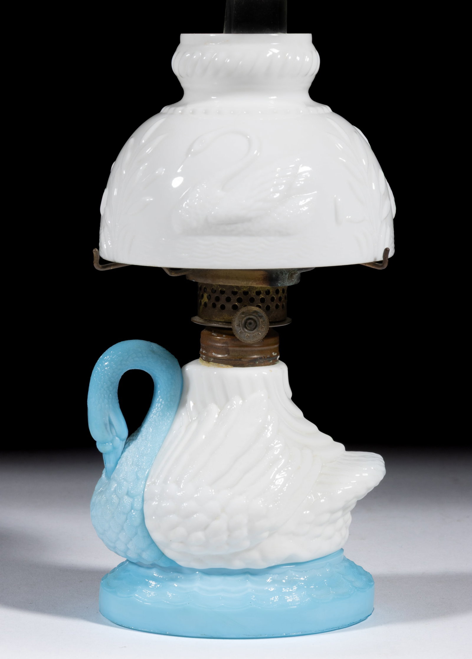RARE SWAN FIGURAL MINIATURE LAMP: RARE SWAN FIGURAL MINIATURE LAMP, opaque white swan font, opaque blue neck and oval base, underside of the base with some light mottling and having a plain table ring, matching patterned opa