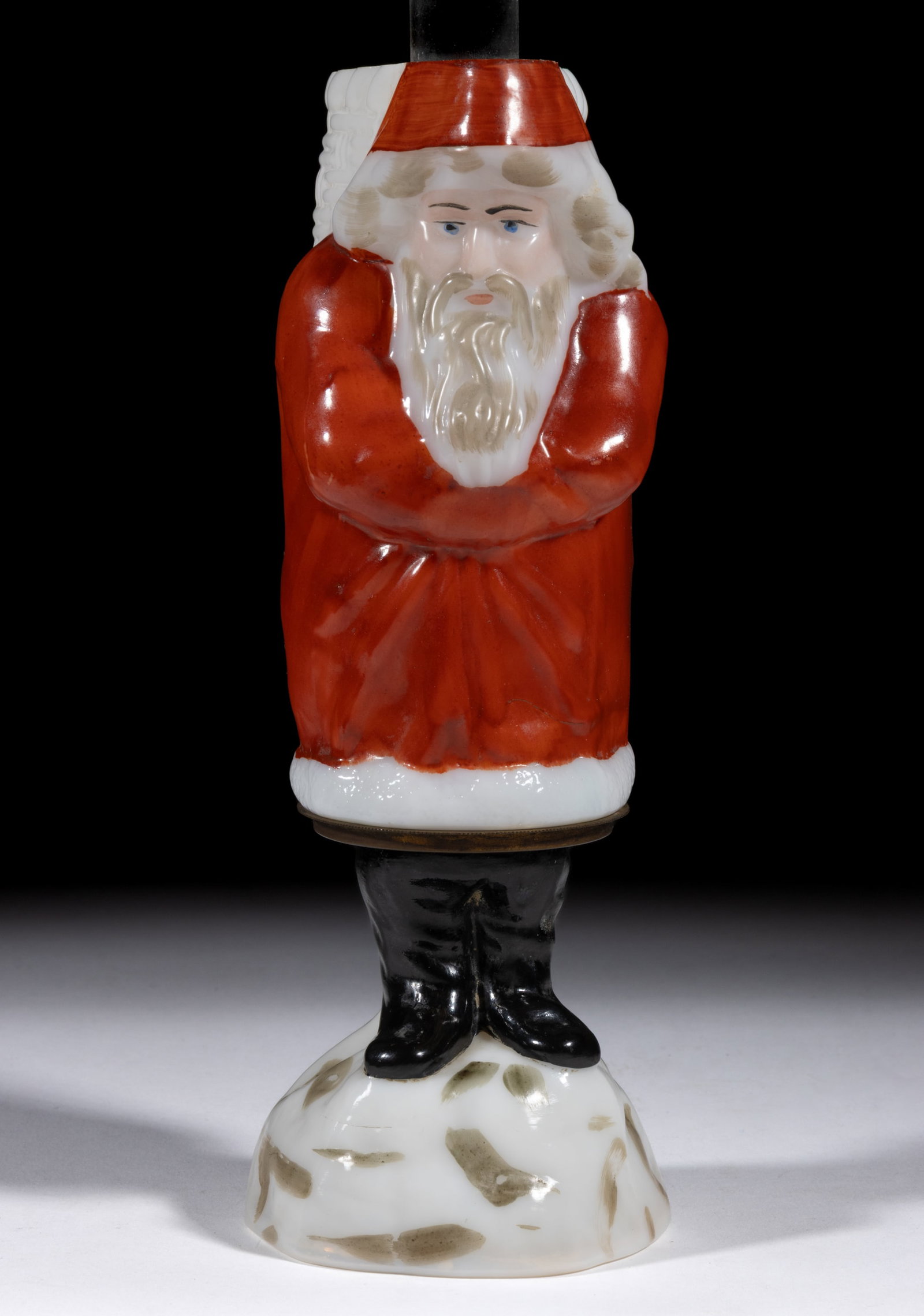 SANTA CLAUS FIGURAL MINIATURE LAMP: SANTA CLAUS FIGURAL MINIATURE LAMP, opaque white with red, black and gray decoration, head and body form the shade with red decoration to the top and bottom, legs and boots standing on a mound of