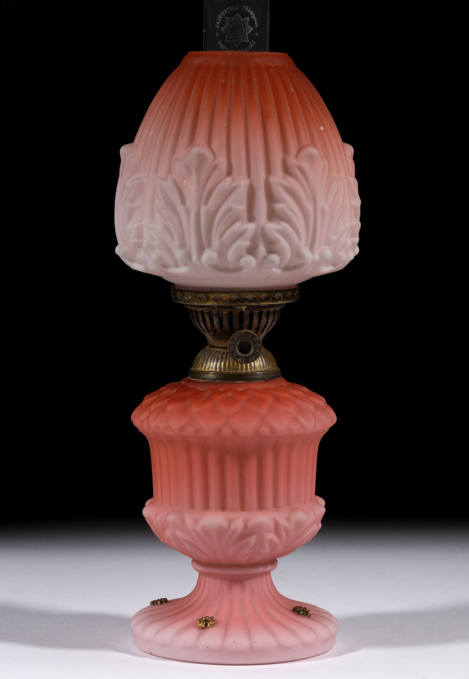 ACANTHUS LEAF AND RIB PATTERNED SATIN GLASS MINIATURE LAMP: ACANTHUS LEAF AND RIB PATTERNED SATIN GLASS MINIATURE LAMP, opal cased shaded dark to light apricot satin glass, font with concave ribbed band under a domed petal shoulder, pedestal base with lar