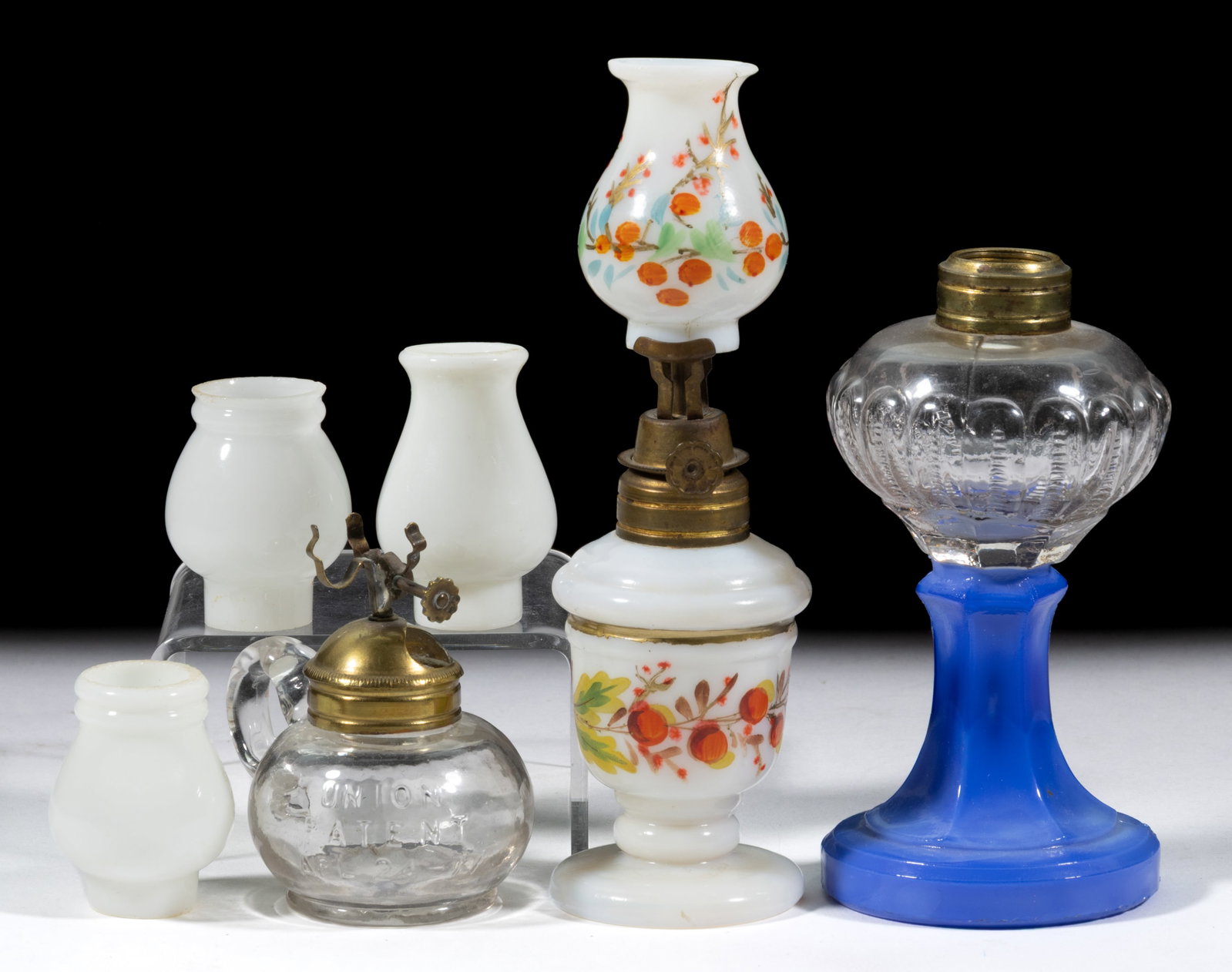 ASSORTED MINIATURE LAMPS AND SHADES, LOT OF SIX: ASSORTED MINIATURE LAMPS AND SHADES, LOT OF SIX, comprising of three lamps, including a Looped Zipper/Smith I, fig. 11 right, having a mottled opaque blue base and colorless font; an opaque white with