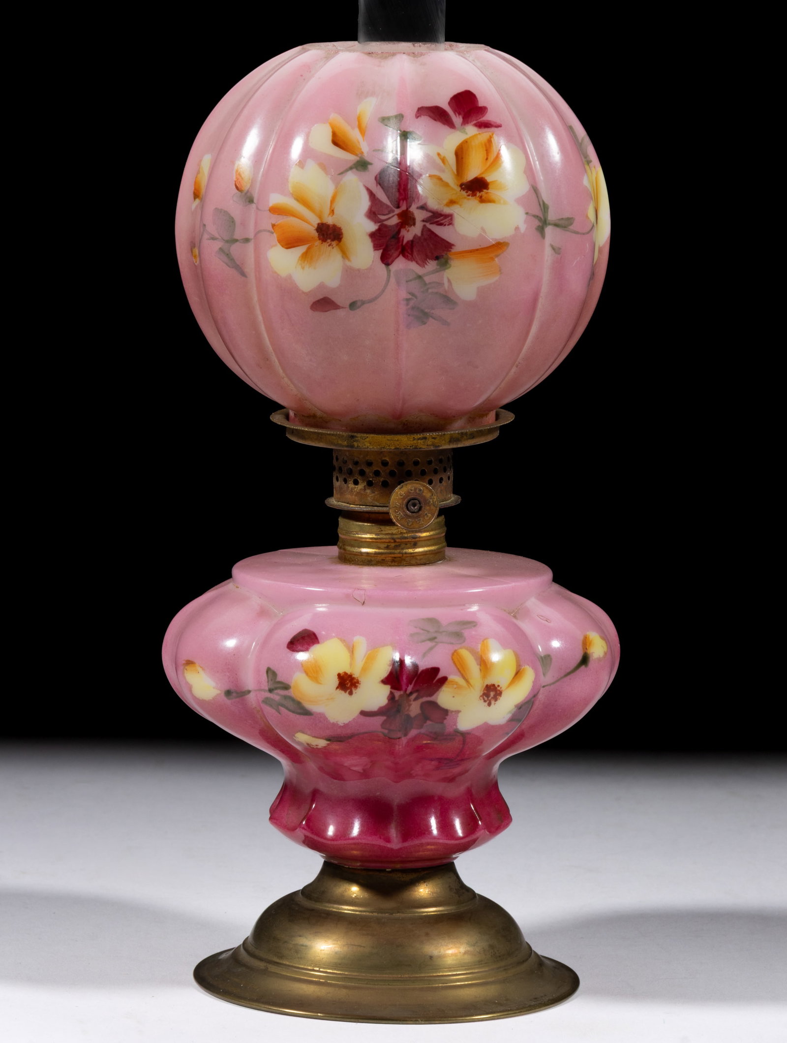 DUCHESS VICTORIAN DECORATED MINIATURE LAMP: DUCHESS VICTORIAN DECORATED MINIATURE LAMP, opaque white with light to dark pink staining, polychrome floral decoration, lobed pyriform font with brass pedestal foot, matching pattern and decorated ba
