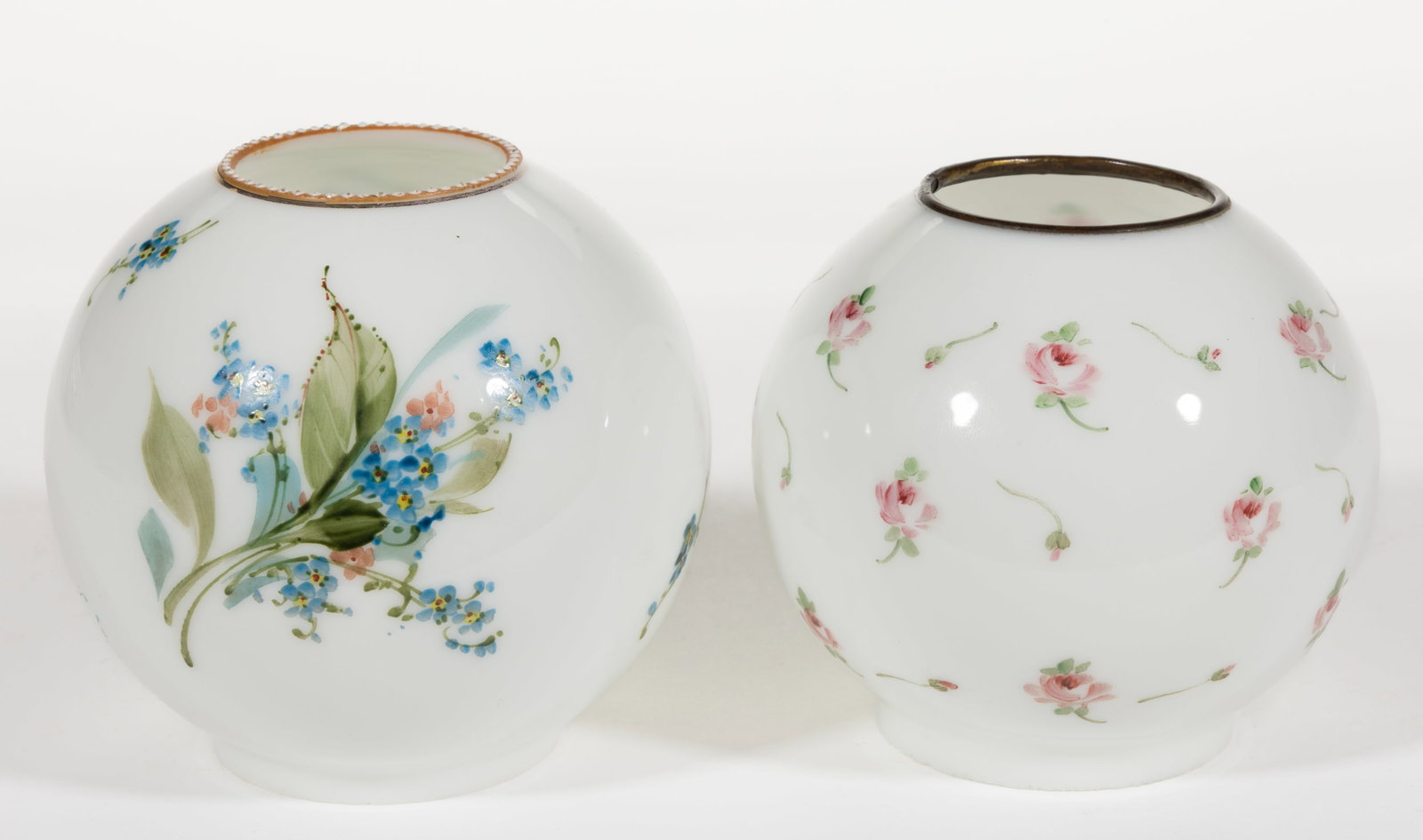 ASSORTED KEROSENE MINIATURE LAMP SHADES, LOT OF TWO: ASSORTED KEROSENE MINIATURE LAMP SHADES, LOT OF TWO, opaque white with polychrome decoration, ball forms, one example having scattered pink roses and a brass heat rim to the top rim and remaining