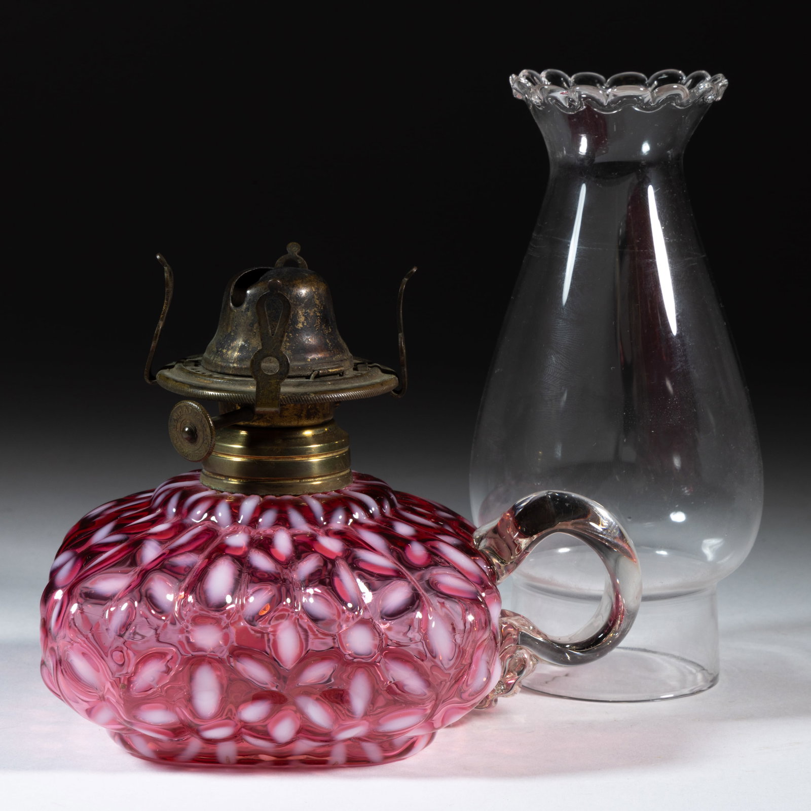 HOBBS NO. 341 / SNOWFLAKE KEROSENE FINGER LAMP: HOBBS NO. 341 / SNOWFLAKE KEROSENE FINGER LAMP, Ruby/cranberry opalescent font, applied colorless handle, No. 1 Taplin-Brown collar with patent information. Fitted with a period setup comprising 