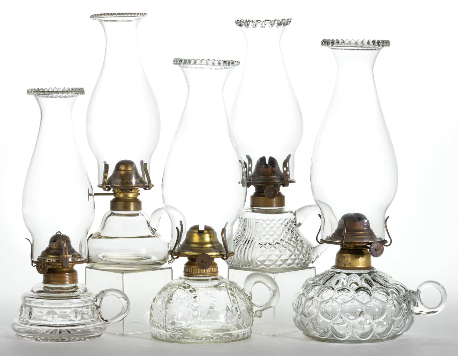 ASSORTED PATTERNED KEROSENE FINGER LAMPS, LOT OF FIVE: ASSORTED PATTERNED KEROSENE FINGER LAMPS, LOT OF FIVE, colorless, each with an applied colorless handle, patterns include a Corn in Shield with a dotted base; a Fishscale; a Diamond Point with Fi