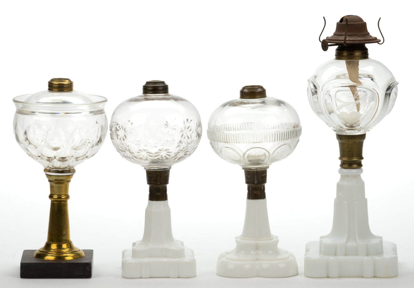 ASSORTED PATTERN HOBBS AND OTHER KEROSENE STAND LAMPS, LOT OF FOUR: ASSORTED PATTERN HOBBS AND OTHER KEROSENE STAND LAMPS, LOT OF FOUR, colorless fonts, comprising of a Hobbs Star with an opaque white Blackberry base; a Quad Loop with engraved panels and an opaque whi