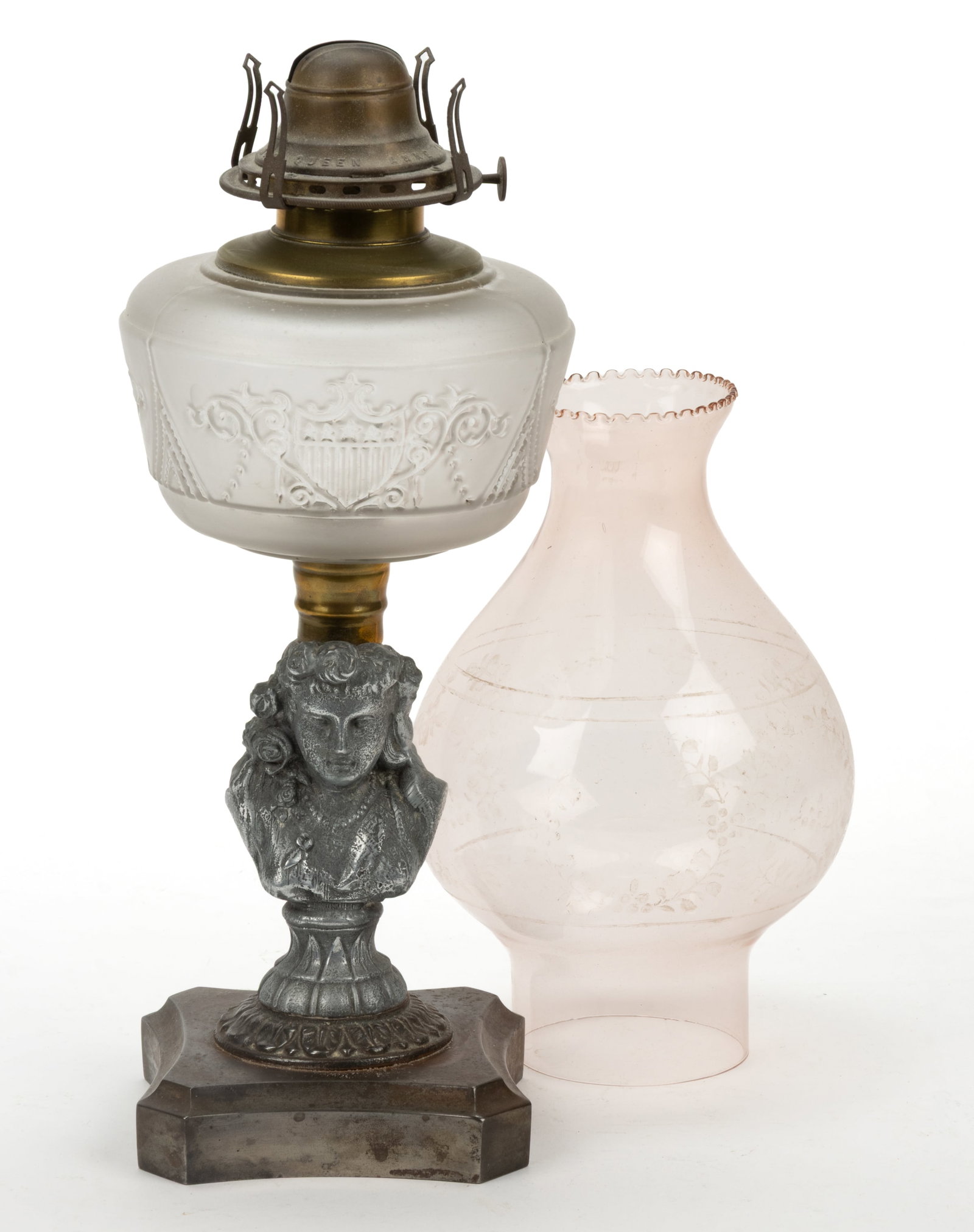 PANELED SHIELD WITH FIGURAL STEM KEROSENE STAND LAMP: PANELED SHIELD WITH FIGURAL STEM KEROSENE STAND LAMP, colorless with frosted finish font, embossed with shield and beading, cast-spelter stem depicting a young woman with long hair and a beaded neckla