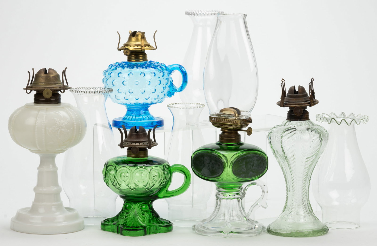 ASSORTED PATTERNED COLORED GLASS KEROSENE FINGER AND STAND LAMPS, LOT OF FIVE (1 of 1)