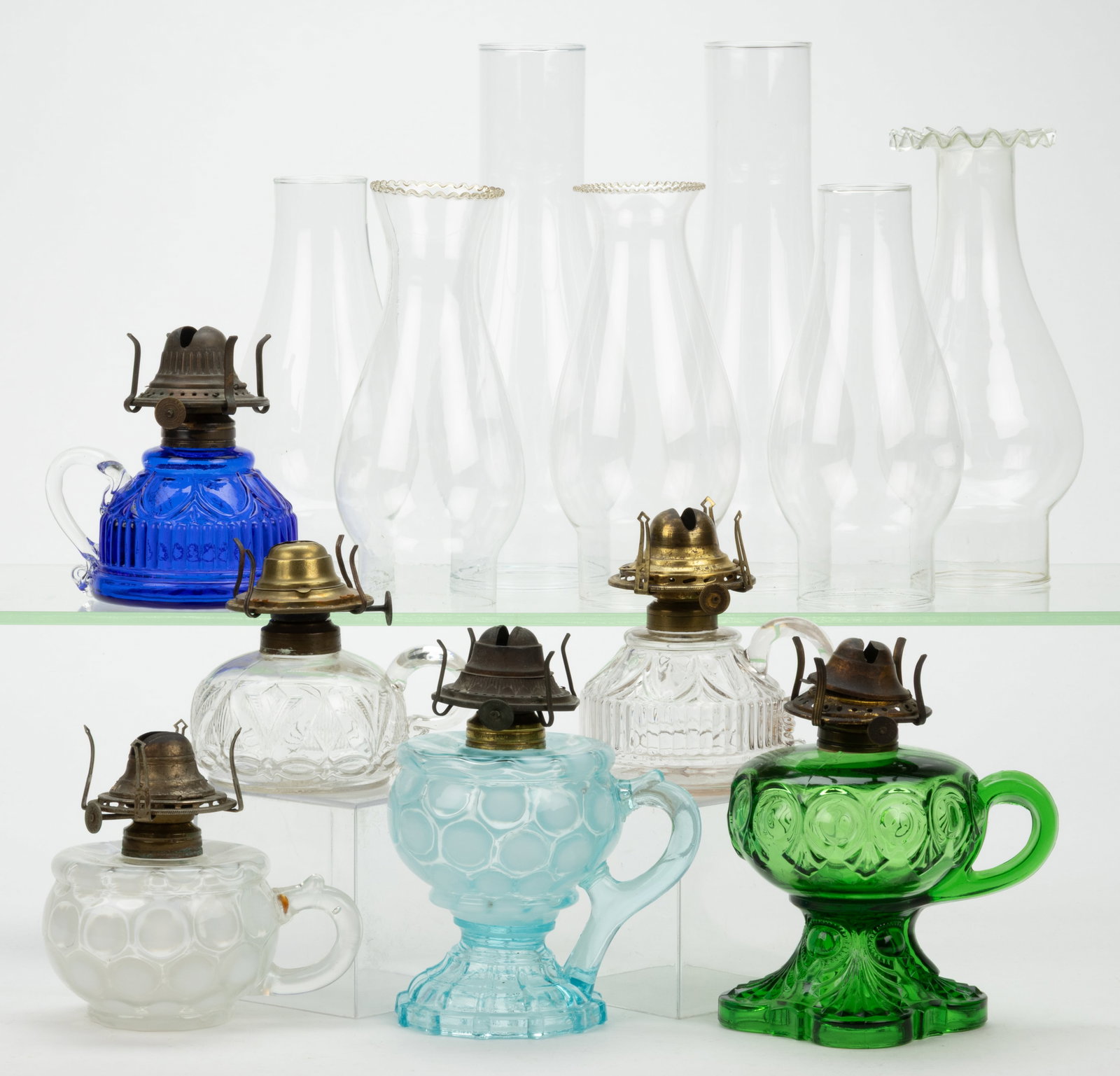 ASSORTED PATTERNED KEROSENE FINGER LAMPS, LOT OF SIX: ASSORTED PATTERNED KEROSENE FINGER LAMPS, LOT OF SIX, various colors, patterns comprising of two Mix and Match with Coin Spot fonts, including a blue opalescent footed and a colorless opalescent examp