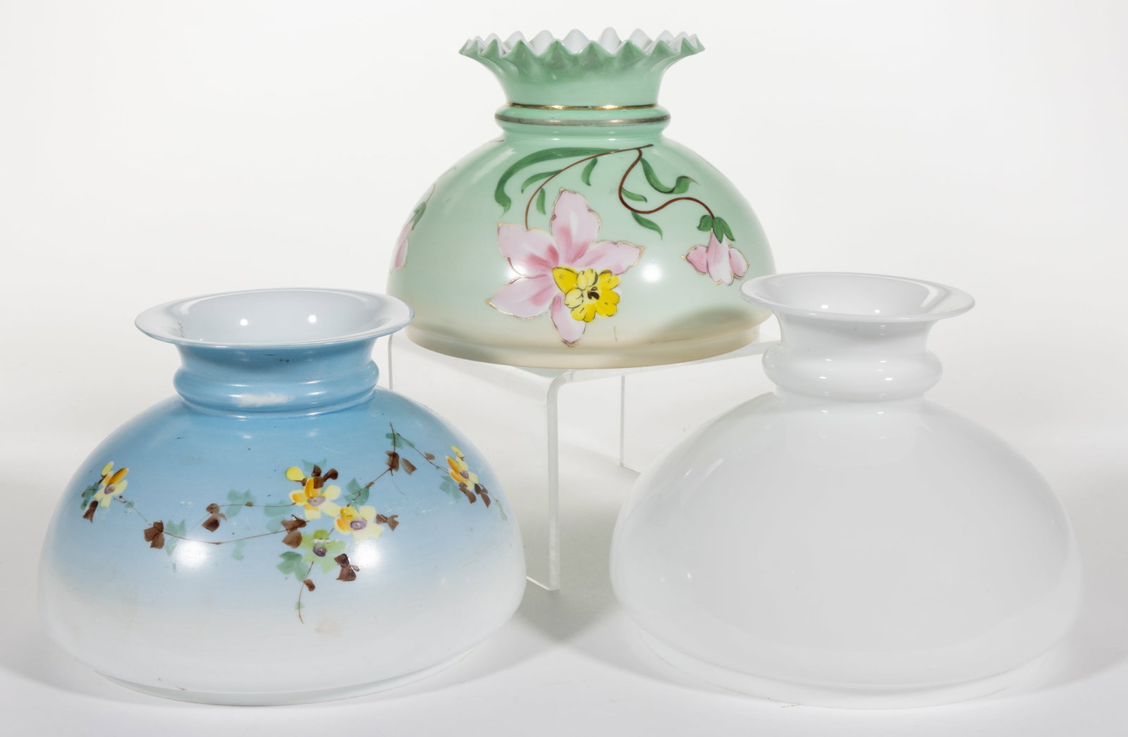 ASSORTED KEROSENE LAMP SHADES, LOT OF THREE: ASSORTED KEROSENE LAMP SHADES, LOT OF THREE, opaque white, umbrella forms, comprising of two examples with polychrome floral decoration, including one example with a pale green ground and lightly rais