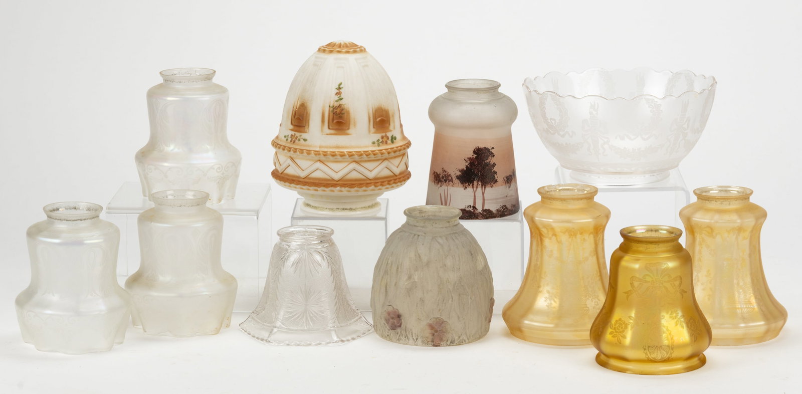 ASSORTED DECORATED GAS LAMP SHADES, LOT OF 11: ASSORTED DECORATED GAS LAMP SHADES, LOT OF 11, comprising of three-piece set of colorless with iridescence examples, having etched stylized decoration; a pair of pale marigold iridescence with fl