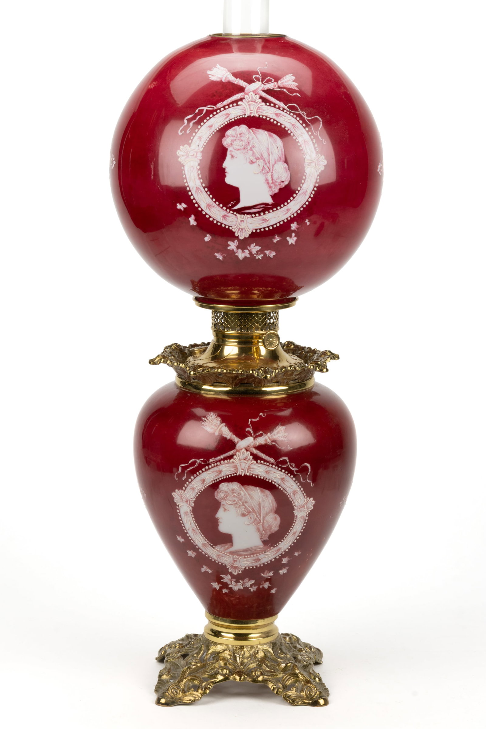 MATTHEWS & WILLARD KEROSENE GONE WITH THE WIND / PARLOR / TABLE LAMP: MATTHEWS & WILLARD KEROSENE GONE WITH THE WIND / PARLOR / TABLE LAMP, glass urn-form vase holder with brass finished cast-iron mounts, vase with a deep dark red ground and white enamel portraits o