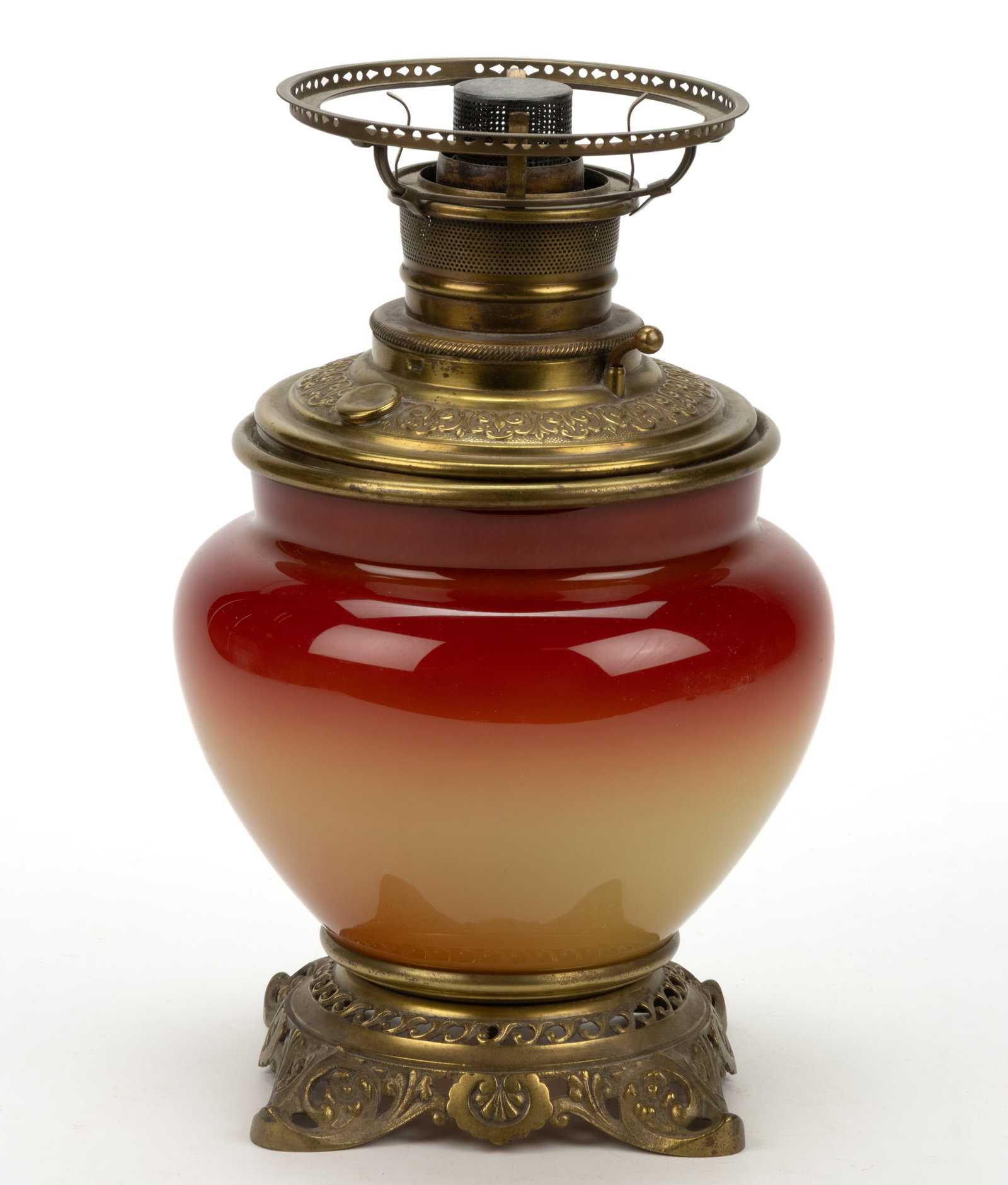 HOBBS CORAL / PEACH BLOW KEROSENE VASE TABLE LAMP BASE: HOBBS CORAL / PEACH BLOW KEROSENE VASE TABLE LAMP BASE, glossy, urn-form vase with metal liner, cast-brass foot with floral and scroll openwork ornamentation. Fitted with a Bristol Brass & Clock C