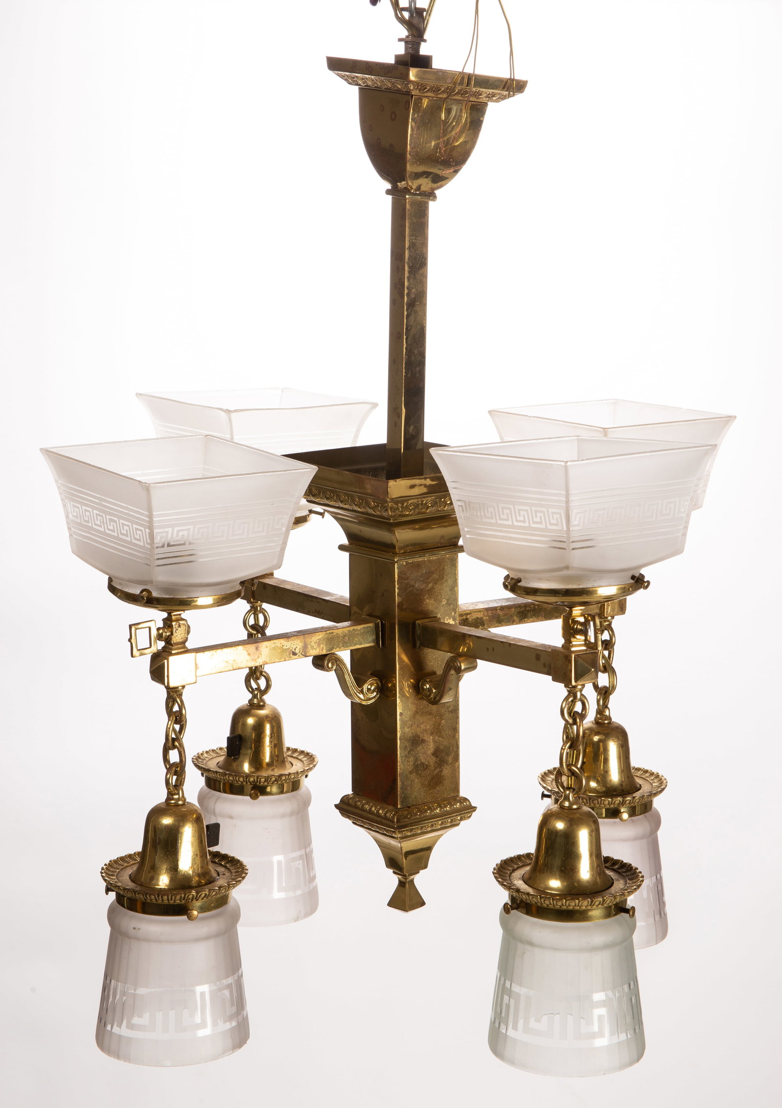 VICTORIAN BRASS COLUMNAR GAS CHANDELIER LAMP: VICTORIAN BRASS COLUMNAR GAS CHANDELIER LAMP, topped with four squared and rounded lamp shades with frosted Greek Key decoration, large central columnar hub with four horizontal arms extending with an