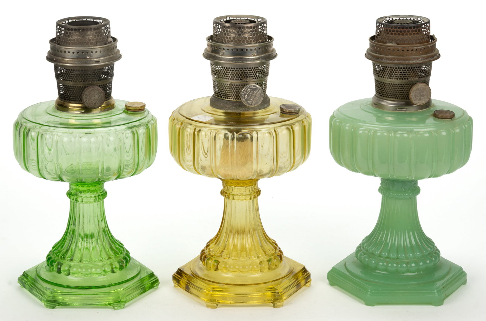 ALADDIN MODELS B-108, B-109, AND B-111 / CATHEDRAL KEROSENE STAND LAMPS, LOT OF THREE: ALADDIN MODELS B-108, B-109, AND B-111 / CATHEDRAL KEROSENE STAND LAMPS, LOT OF THREE, comprising of an Amber Beta Crystal, a Green Beta Crystal, and a Pastel green moonstone example, e