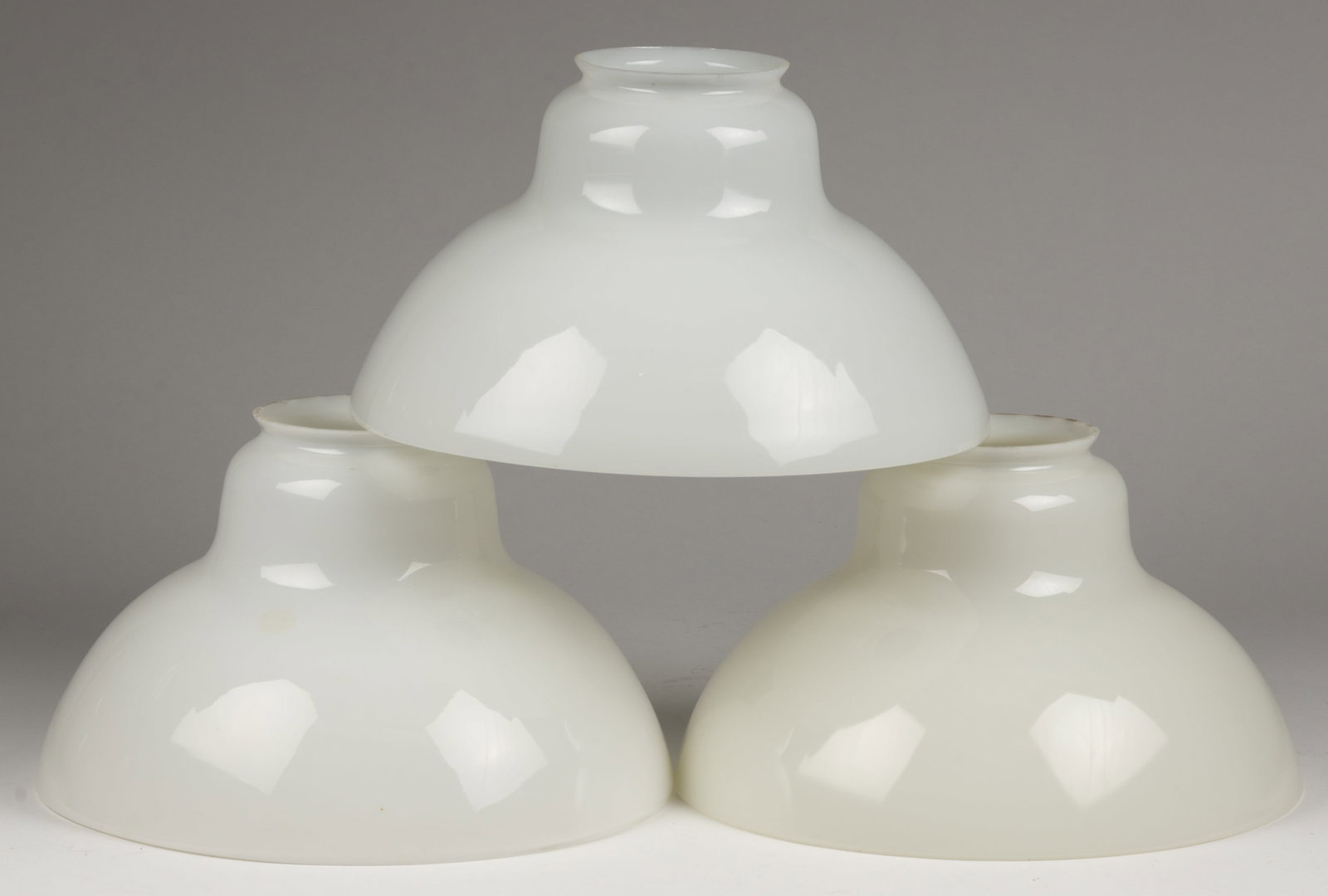 ALADDIN NO. 215 GLASS LAMP SHADES, SET OF THREE: ALADDIN NO. 215 GLASS LAMP SHADES, SET OF THREE, opal, used on Model 5 and 6 hanging lamps, each having a fire polished fitter and ground top rim. The Mantle Lamp Company of America (Aladdin). 1913 to