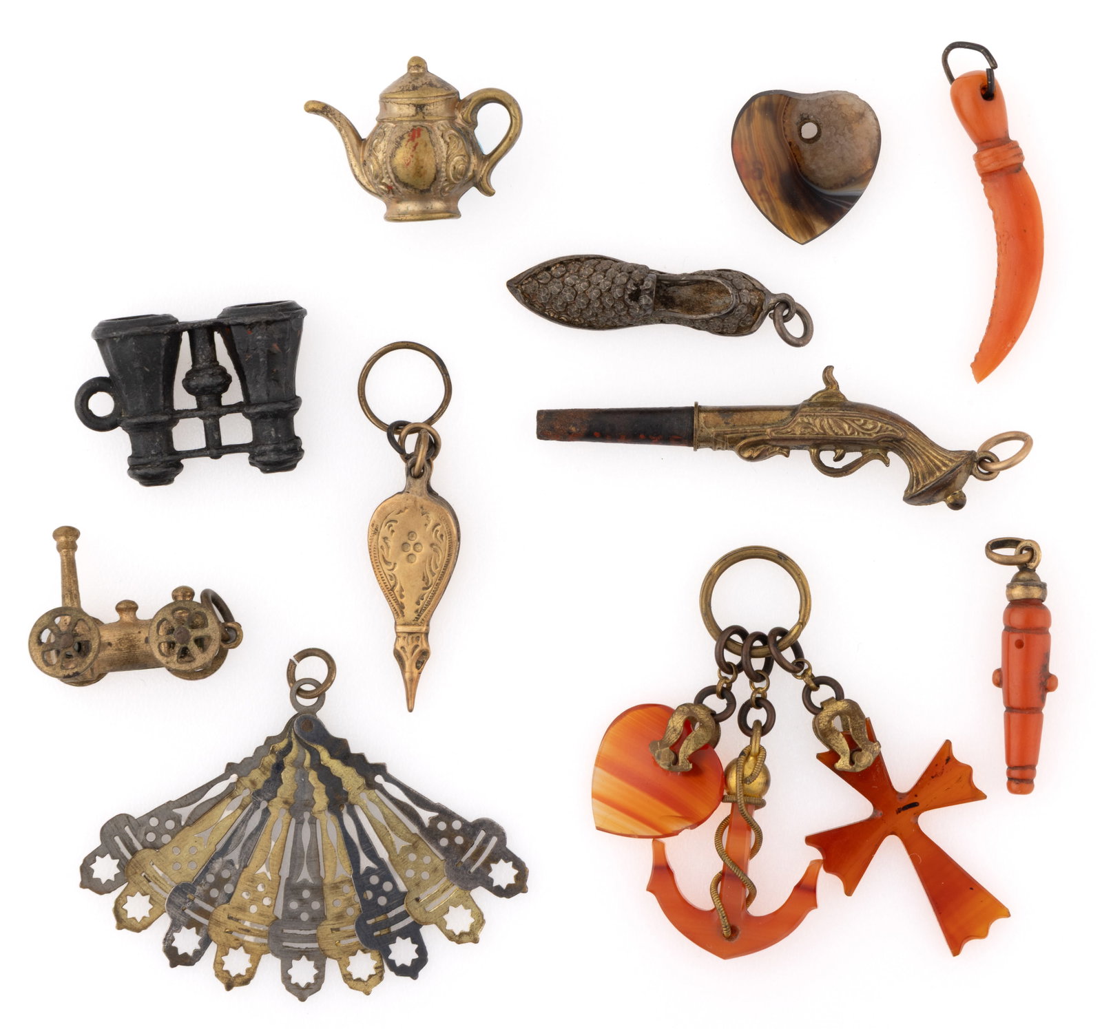 VICTORIAN / ANTIQUE FIGURAL CHARMS / PENDANTS, LOT OF 13: VICTORIAN / ANTIQUE FIGURAL CHARMS / PENDANTS, LOT OF 13, comprising two carved coral pieces featuring a cannon and a dagger / knife, a pistol being a pocket watch key, an agate heart, a group of thre