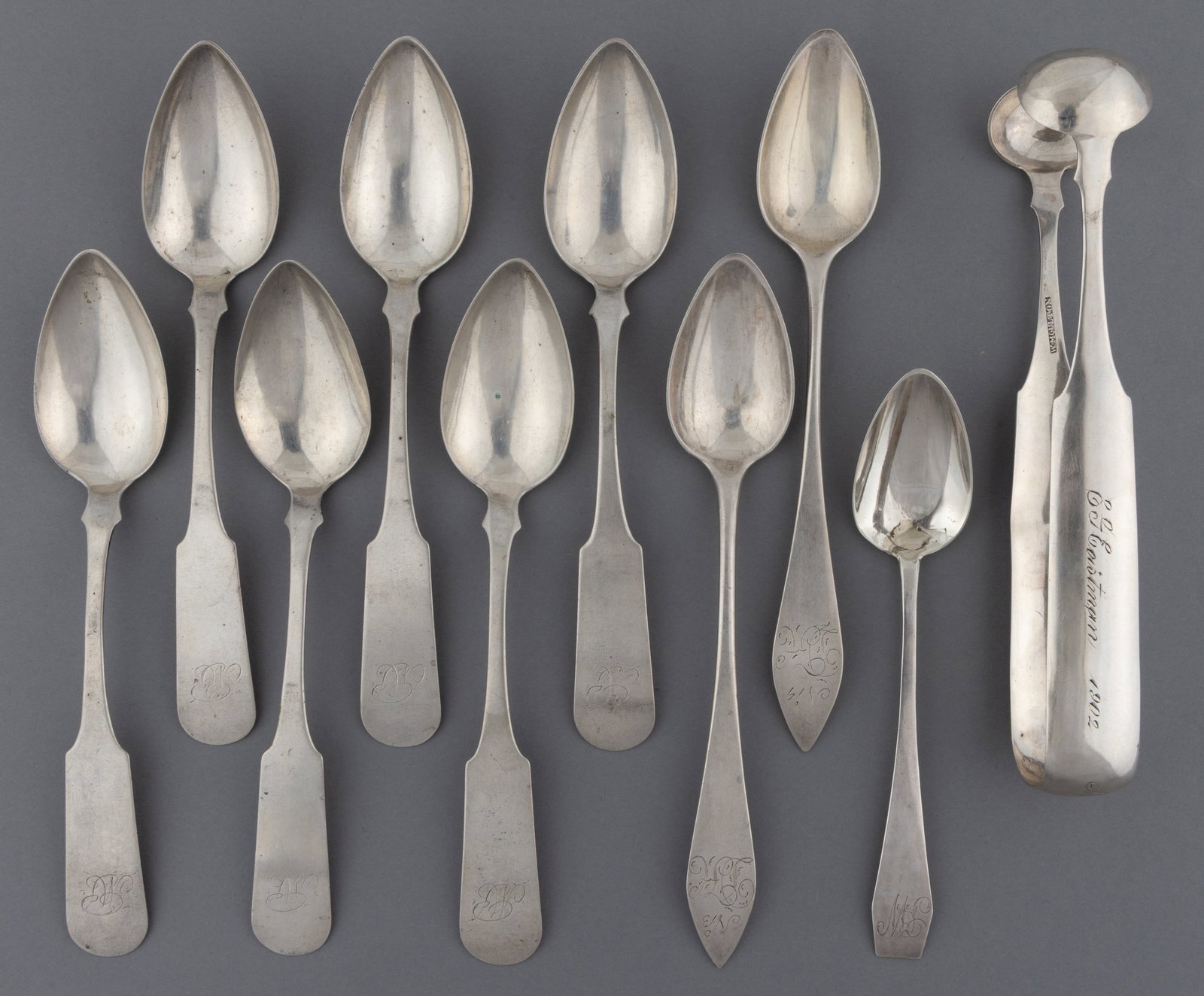 MASSACHUSETTS COIN SILVER TEASPOONS AND SUGAR TONGS, LOT OF TEN: MASSACHUSETTS COIN SILVER TEASPOONS AND SUGAR TONGS, LOT OF TEN, each piece with a personalized engraving to handle; comprising a pair of sugar tongs by William Moulton of Newburyport, MA (active 1796